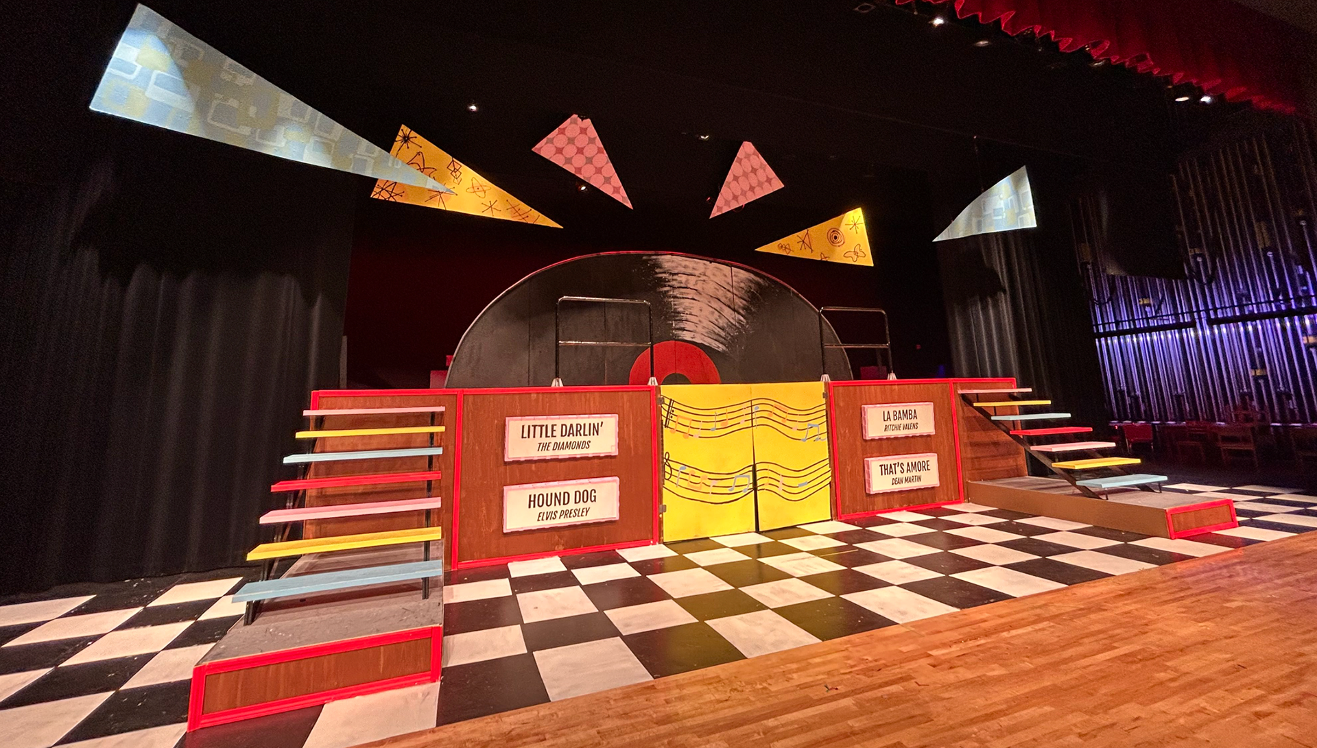 The floor of the stage is painted with a checkerboard pattern common in 1950s diners