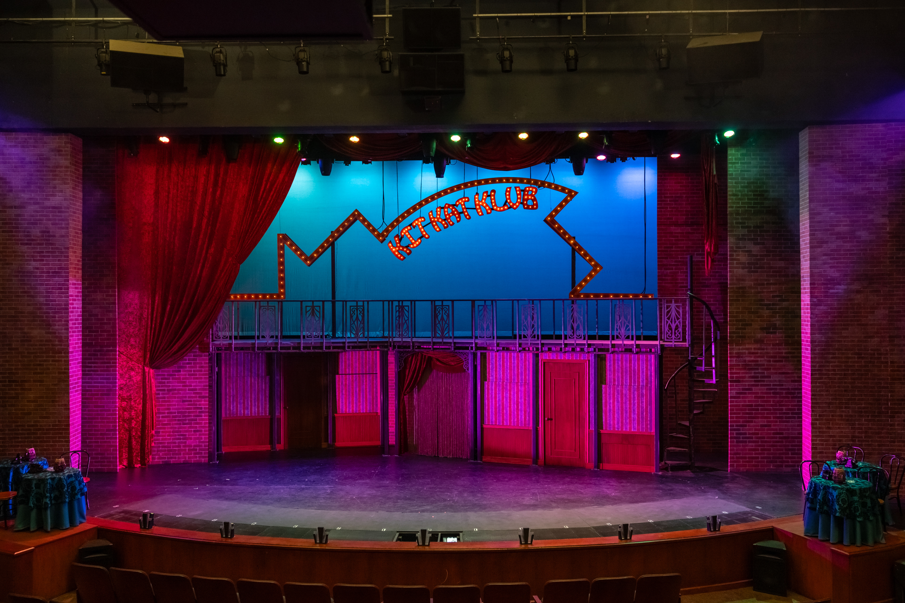 Multi level set with a welded frame and several entrance points, hand painted brick panels mimic the proscenium brick