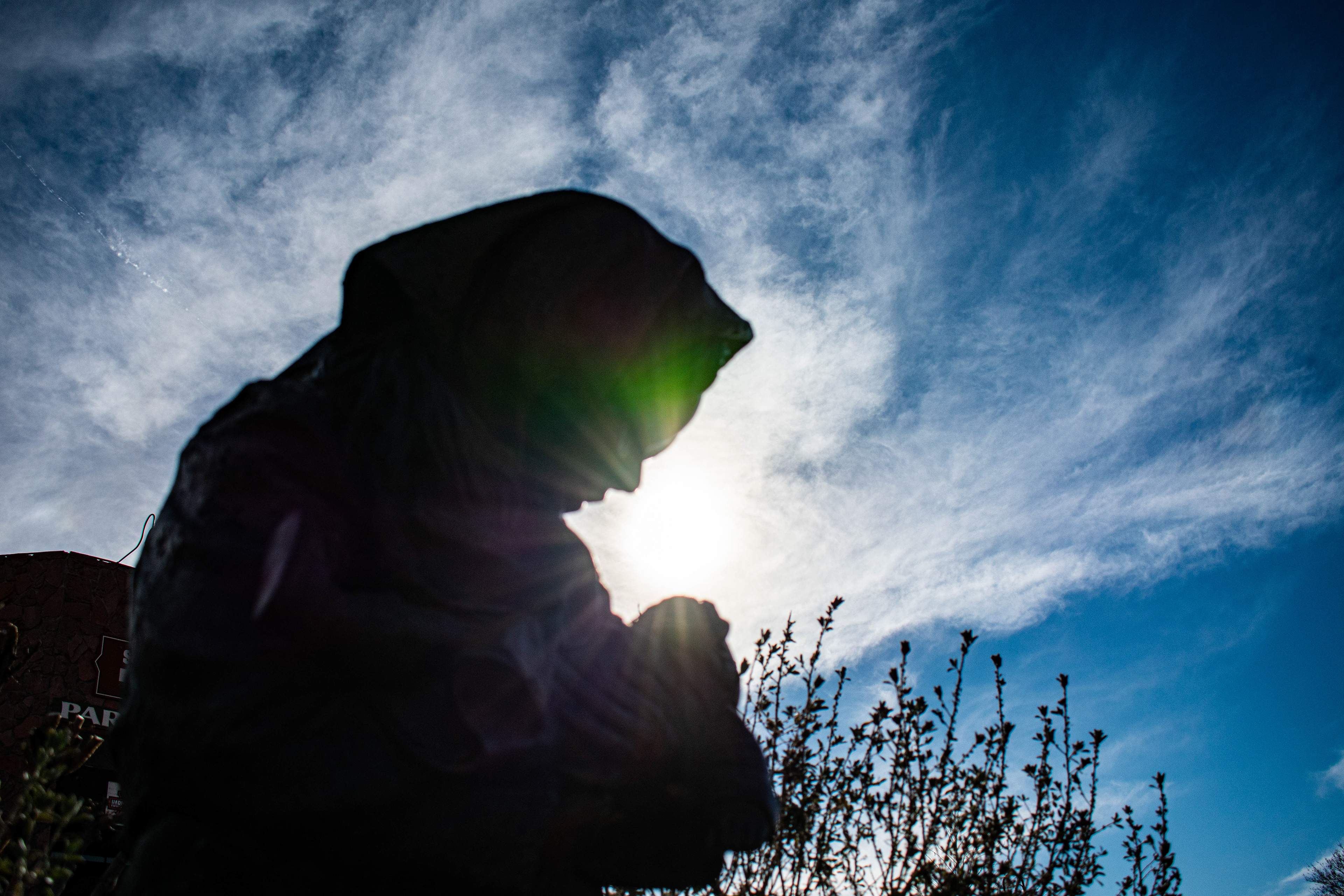 The Sun Behind a Mother and Child Statue
