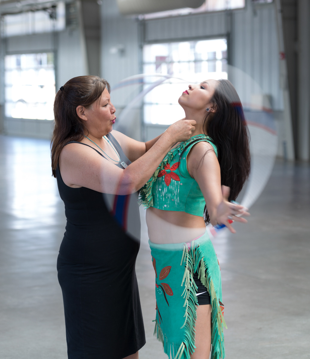 Marian adjusts Sonwai's outfit by Patricia Michaels.