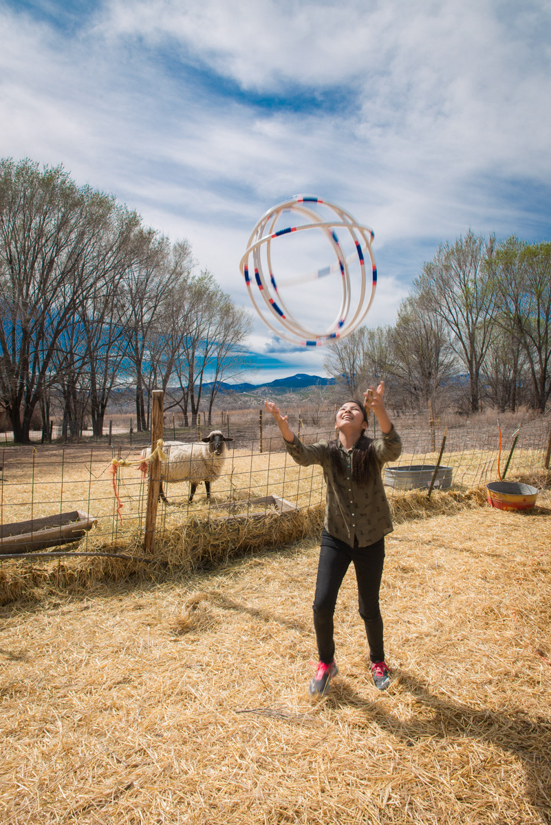 Nizhoni's daughter, Shadé-Phea Denipah-Young, tossing the hoops on the farm.