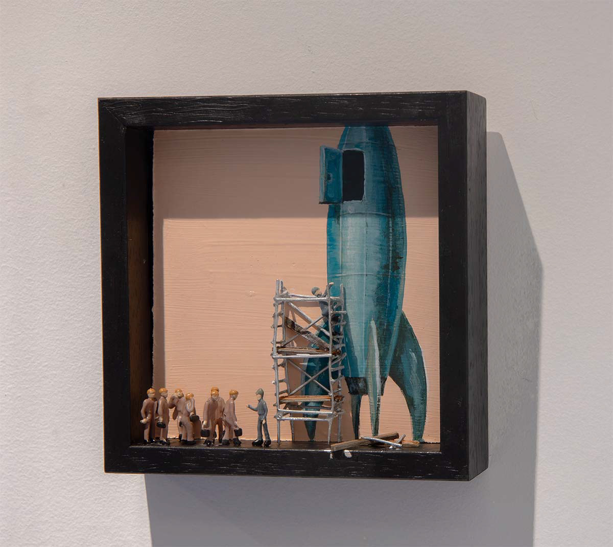 10 x 10 painting showing a line of people in front of a rocket. 