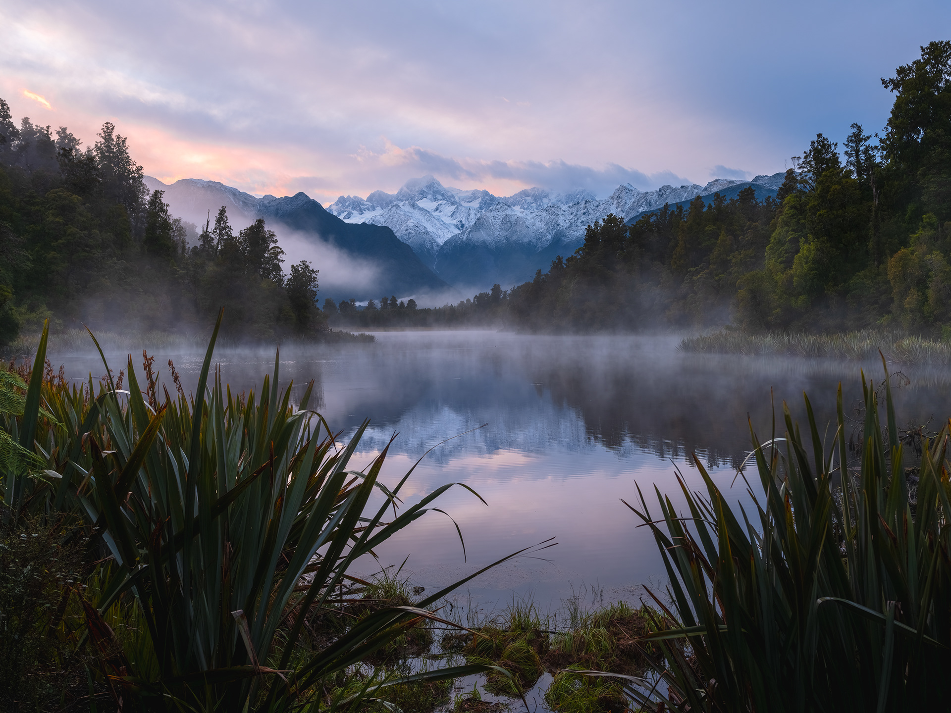 Aoraki/Mount Cook and Mount Tasman rise above Lake Matheson in Westland Tai Poutini National Park