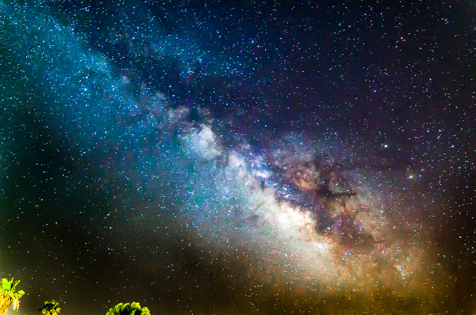 This is my first night trying to shooting the stars which included the Milky Way.  It was a challenge to frame the shot due to how close the Milky Way was to the horizon.  Being lazy I didn't leave the neighborhood, and had to work around the well lit houses around me..  Due to the light bleeding into the slightly dusty desert sky some spot exposure adjustment was necessary that impacted the lower Milky Way cloud shape.  I expect this image to change as I learn more about post processing.
