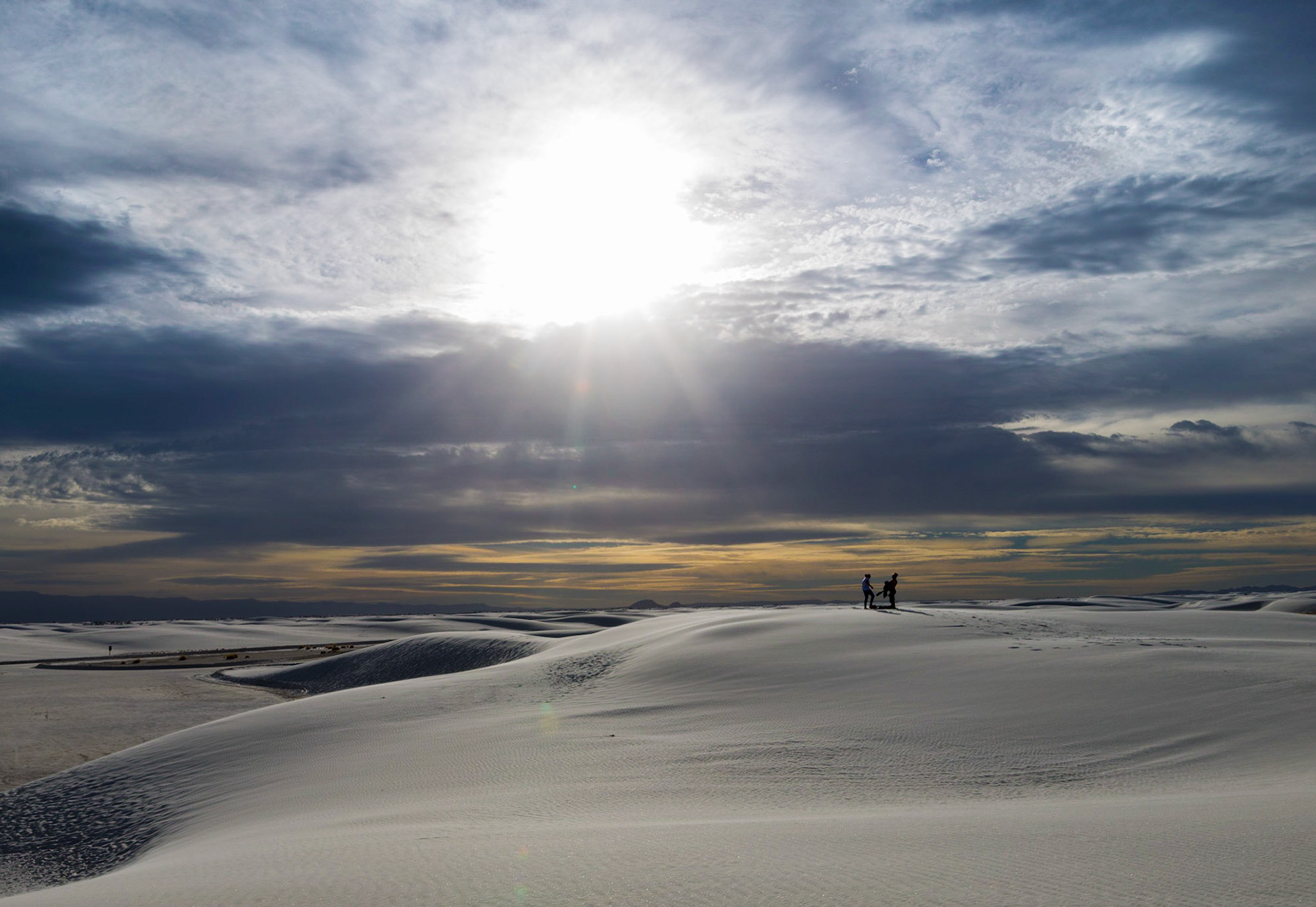 The sunrise breaking over White Sands National Monument caught two women enjoying and playing in the crisp morning and stark white landscape.