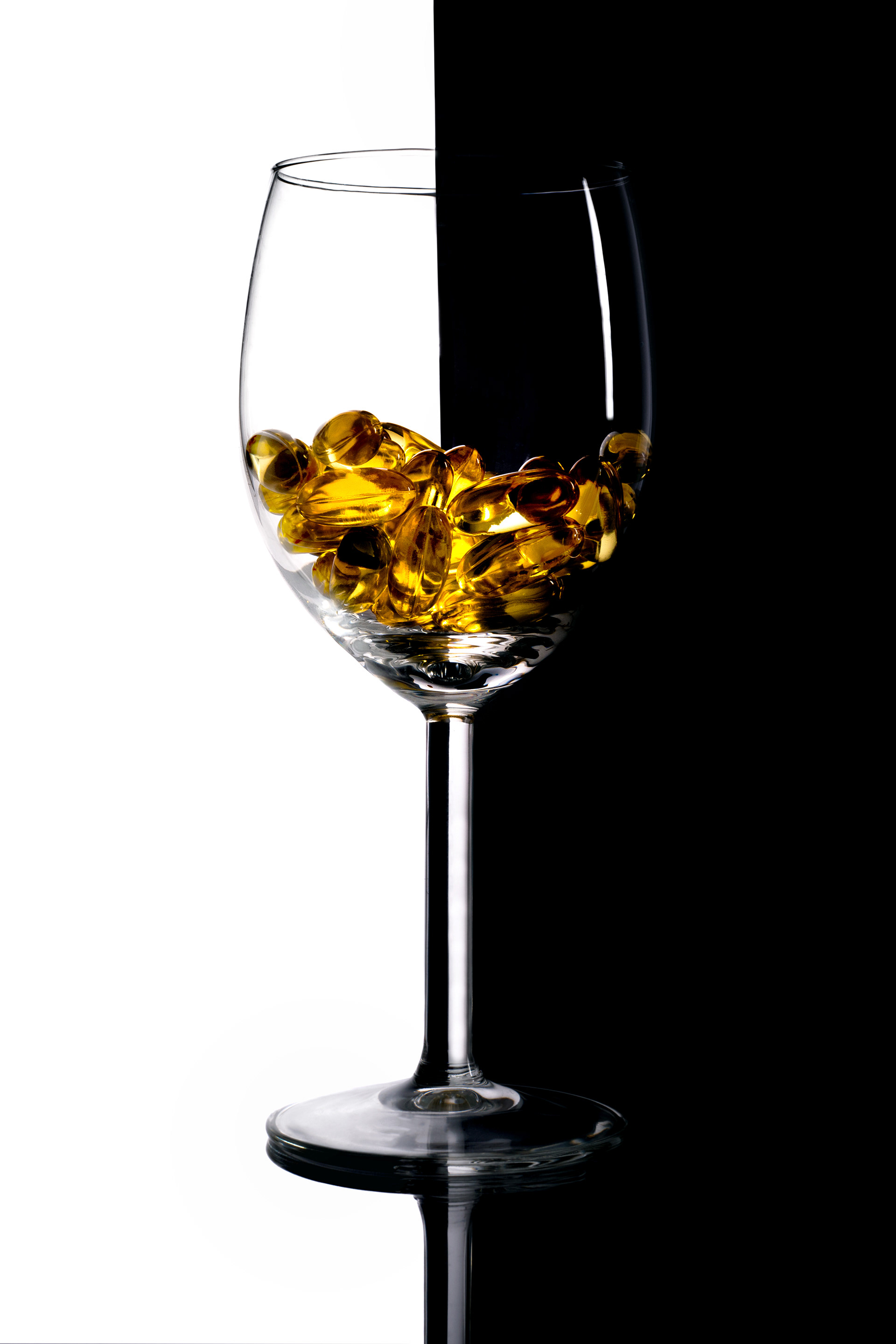 glass vessel with golden fragments against split background