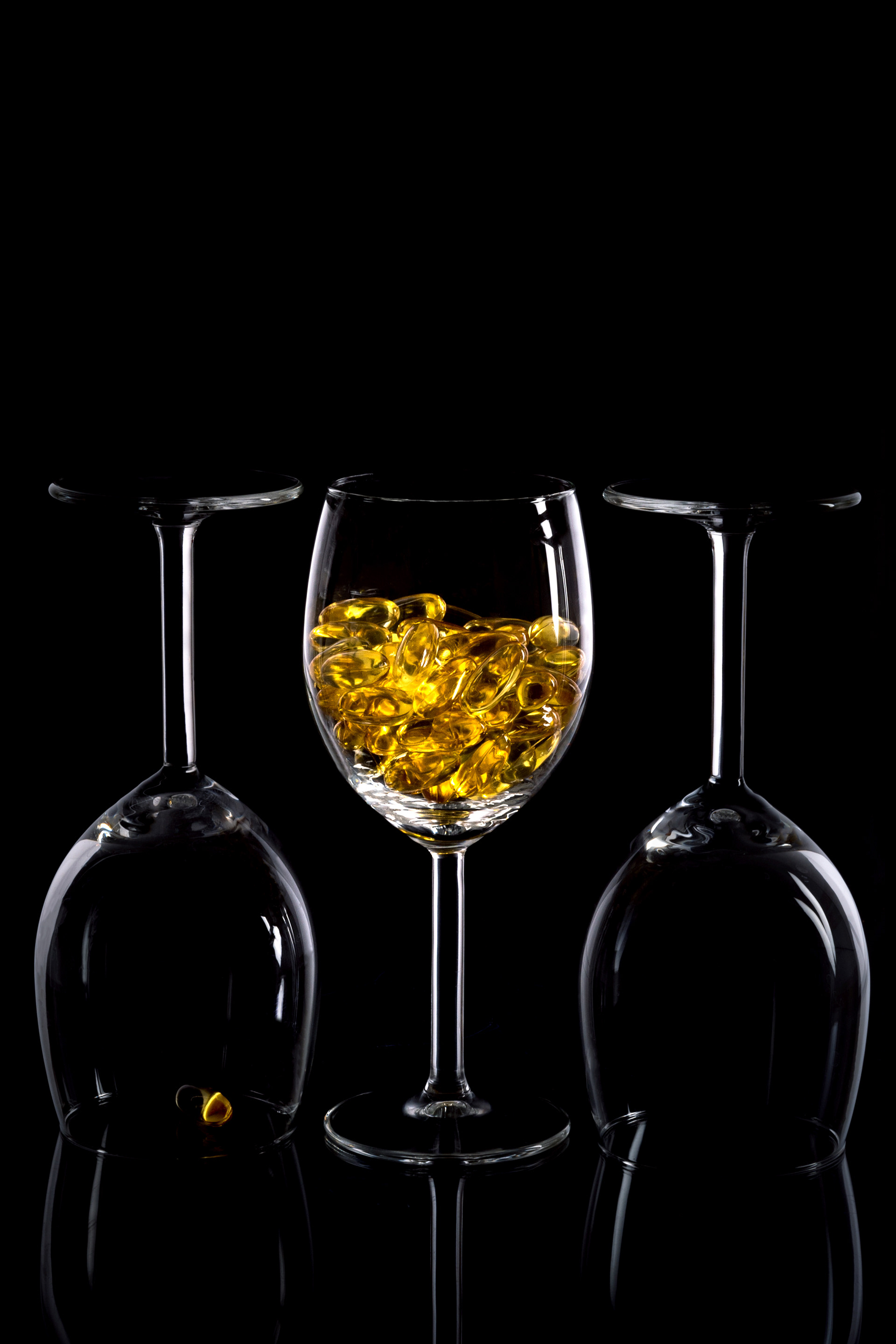 glass vessels arranged in triptych structure on dark background