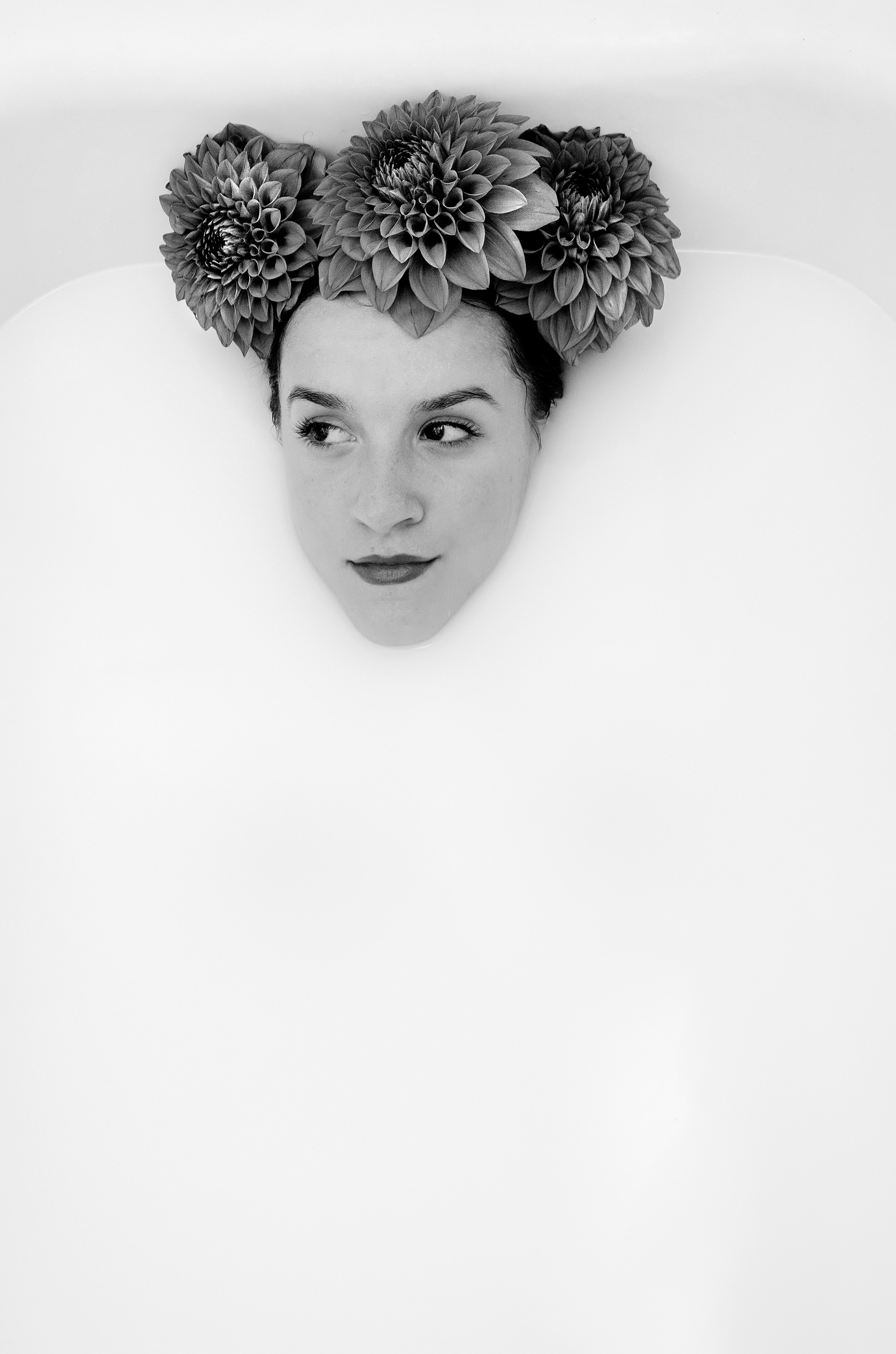 portrait with floral crown in milk referencing Frida Kahlo