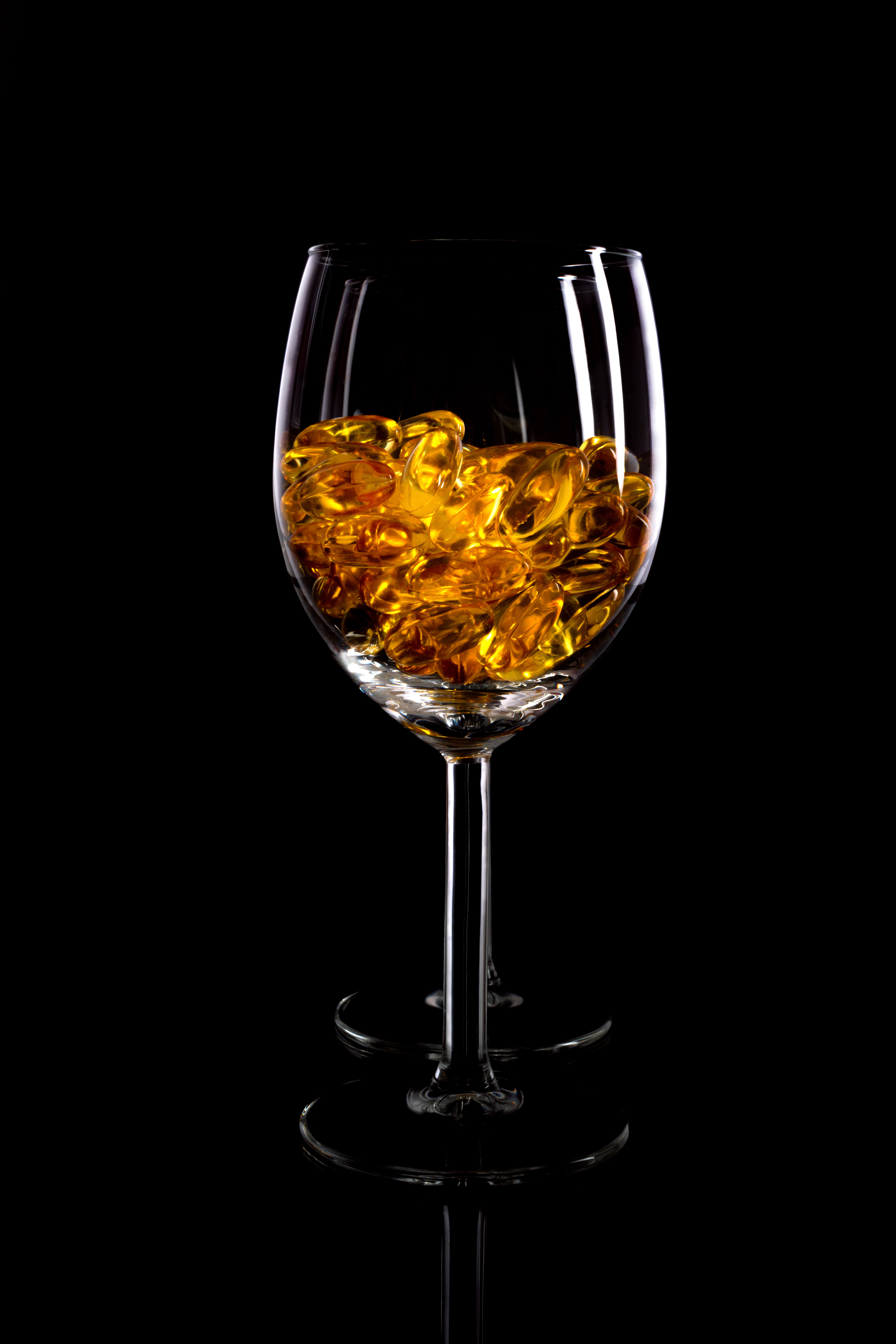 glass vessel with golden fragments on dark background