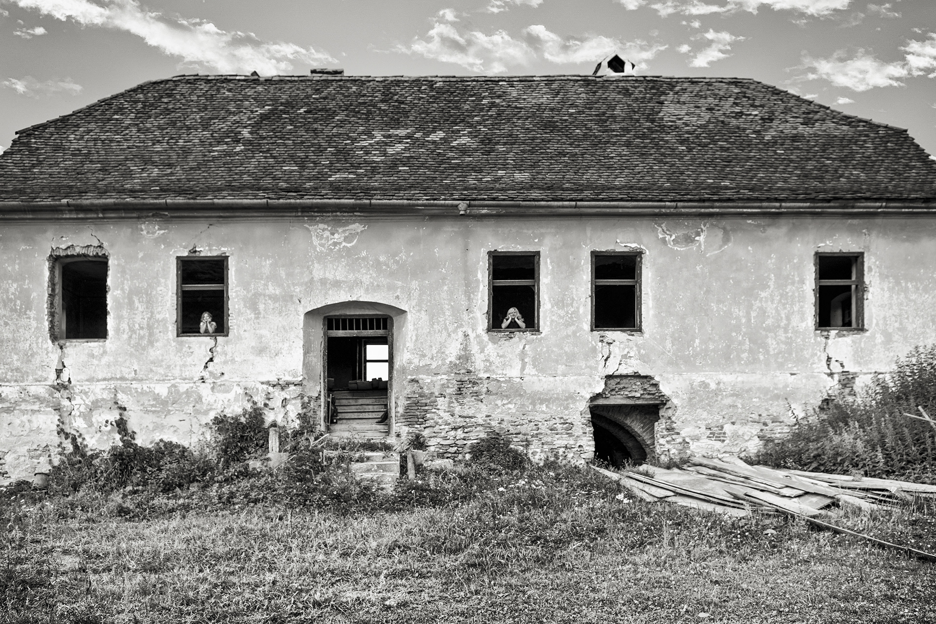 abandoned rural house in open village landscape