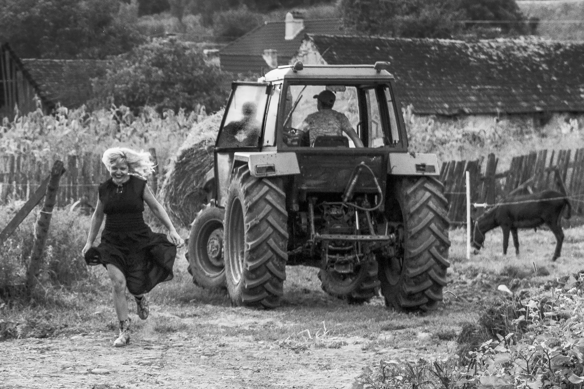girl running near tractor in village environment