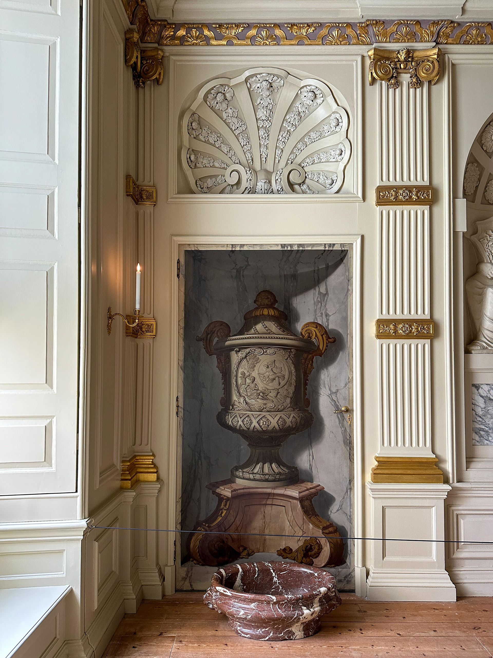 Trompe l'oeill urn on a door in the dining room