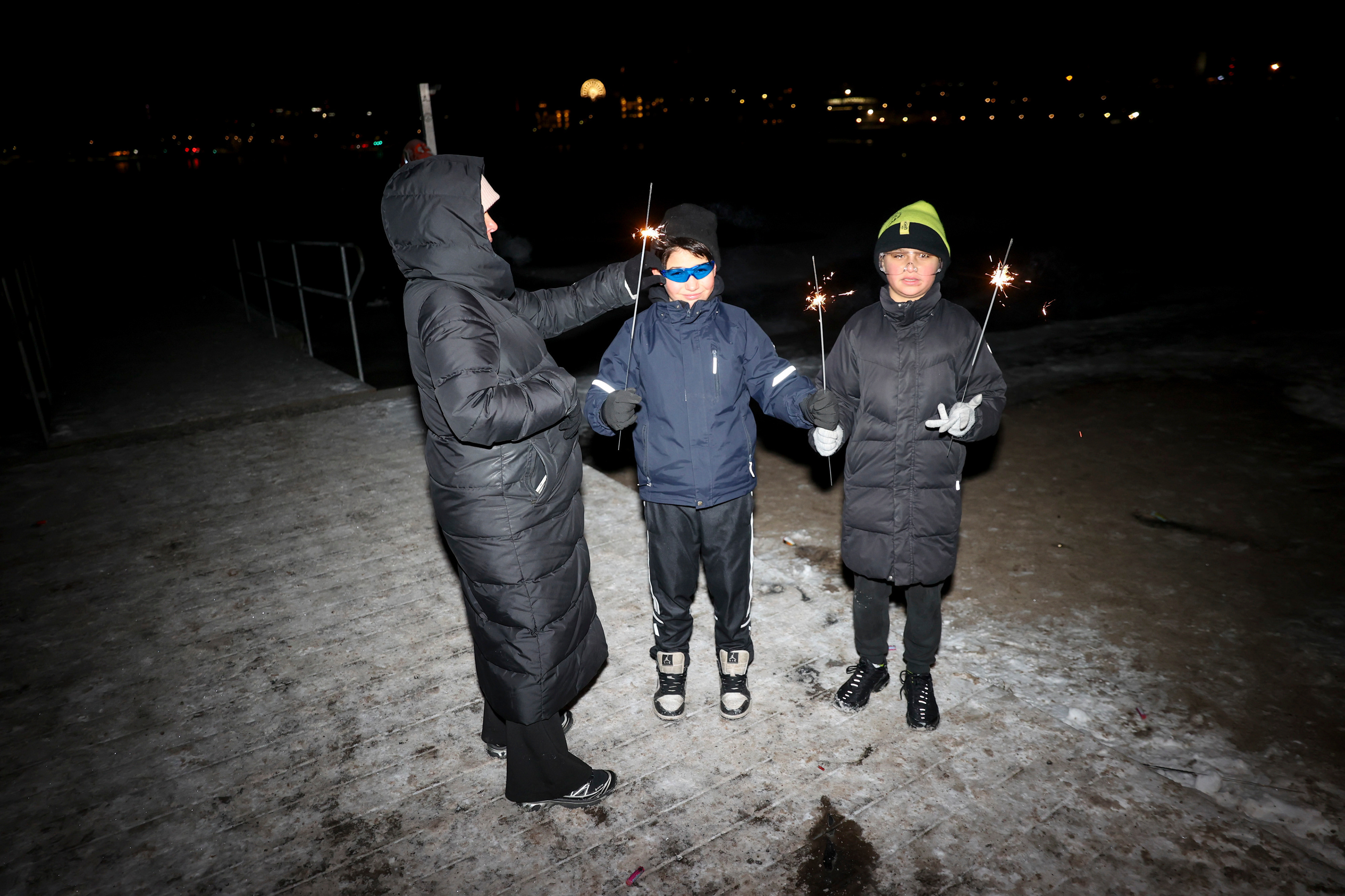 Jasmin Tallbacka, Alex Rouichi and Thiago Karhu in Töölönlahti to celebrate New Year's Eve, 2025.