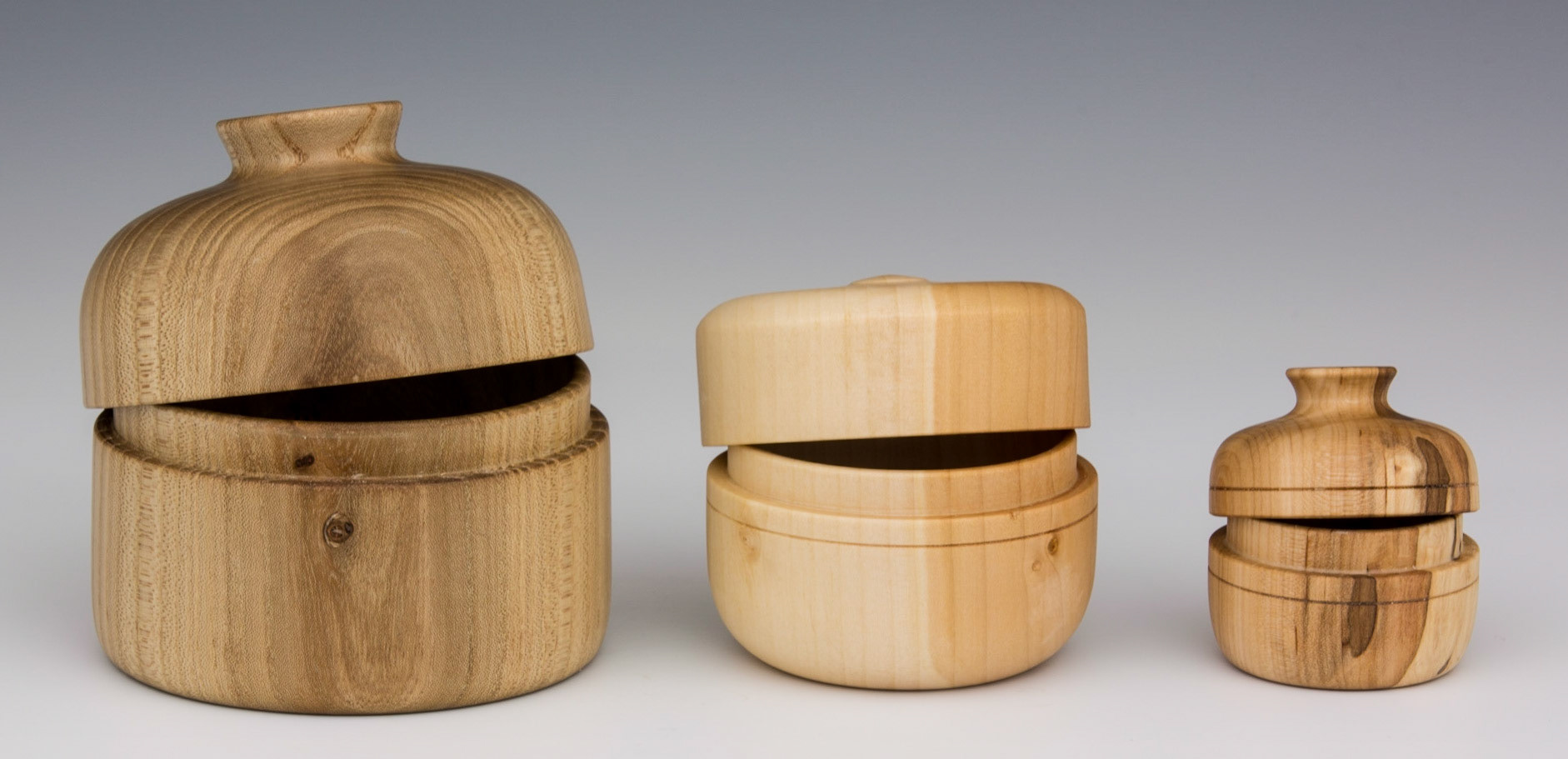 Nested Lidded Boxes of Elm, Willow and Ash - ELM-Diameter: 3 5/8 inches, Height: 3 5/8 inches (E5) WILLOW-Diameter: 2 3/4 inches, Height: 2 1/2 inches (E6) ASH-Diameter: 1 7/8 inches, Height: 1 7/8 inches (E7)