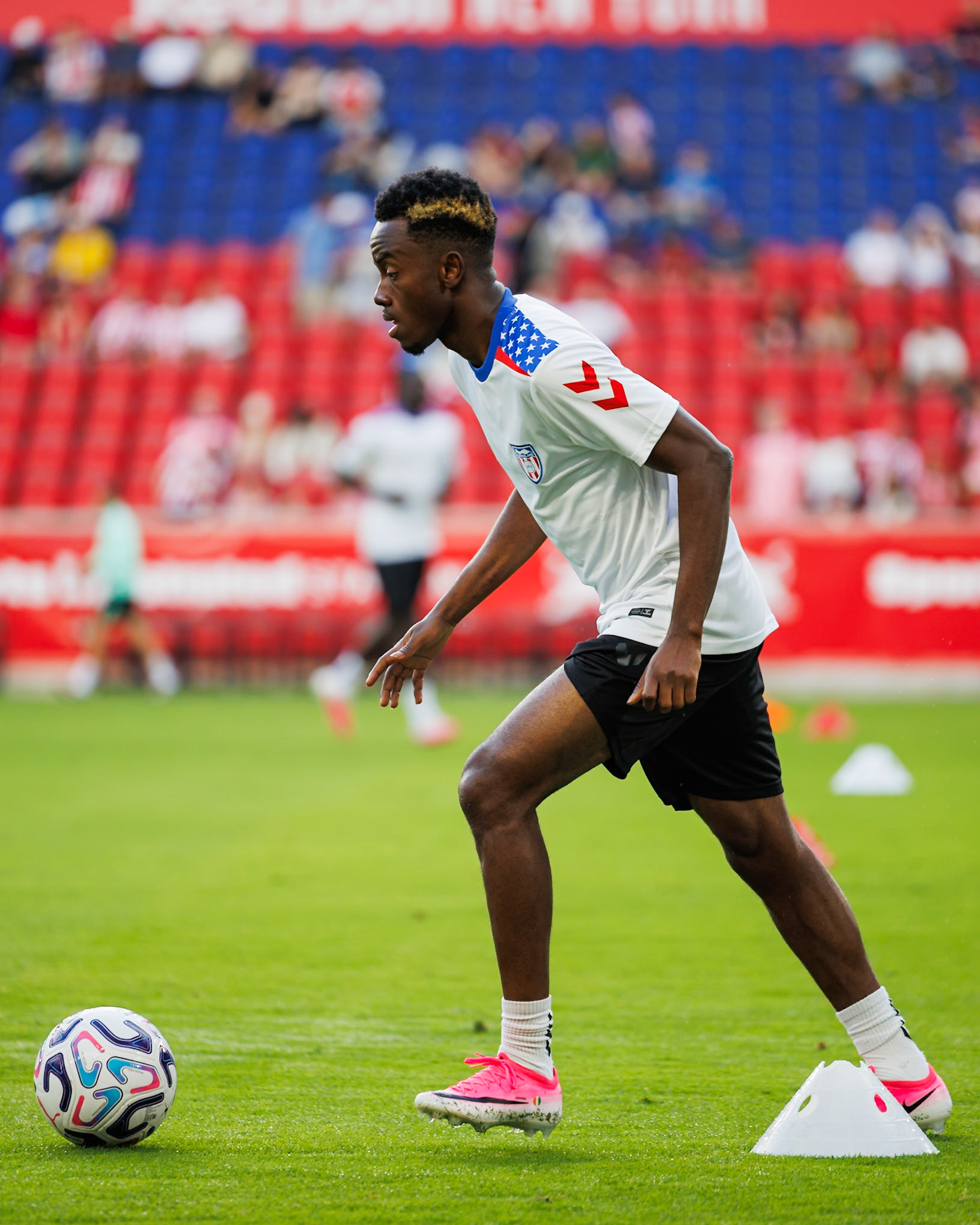Simon Adingra warms up before the match.