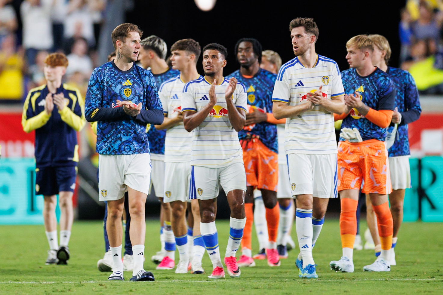 Leeds United players applaud the traveling supporters.