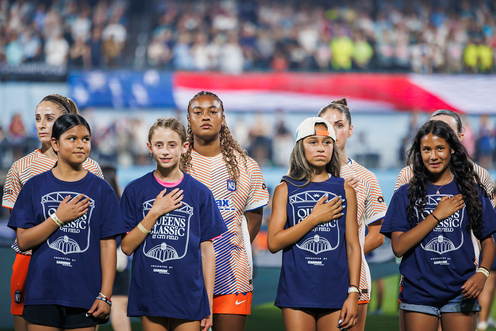 Players stand for the national anthem.