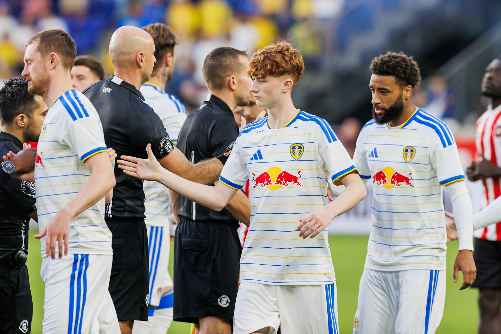 Leeds United and Sunderland AFC players greet before kickoff.