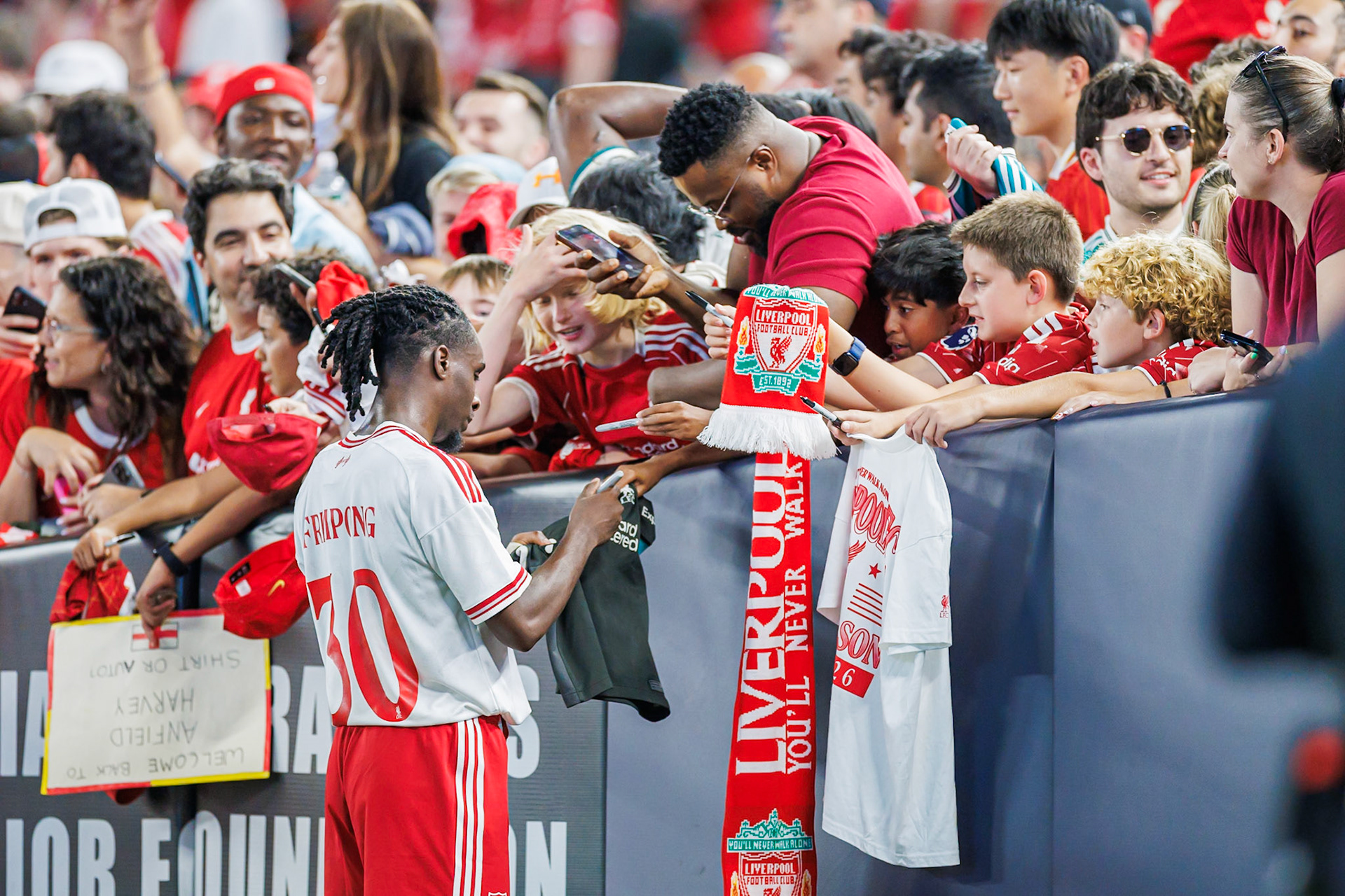 Jeremie Frimpong signs autographs for supporters.