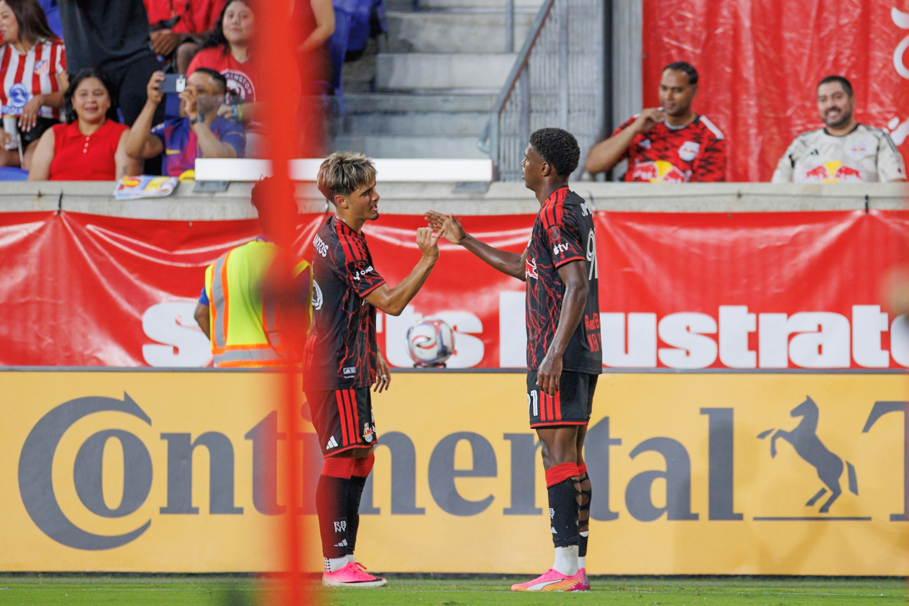 Omar Valencia celebrates with Matthew Dos Santos after scoring for the New York Red Bulls.
