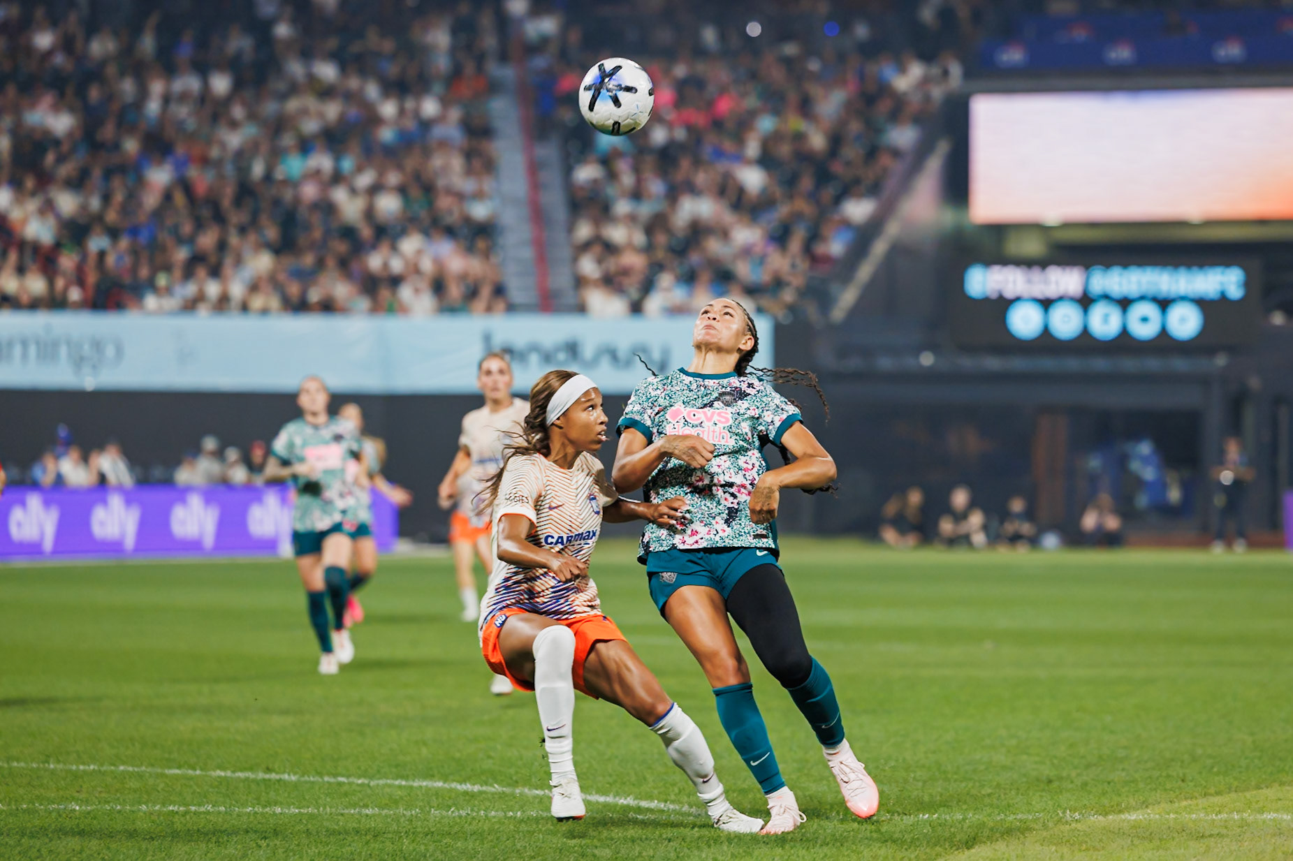 Players battle for possession during The Queens Classic.