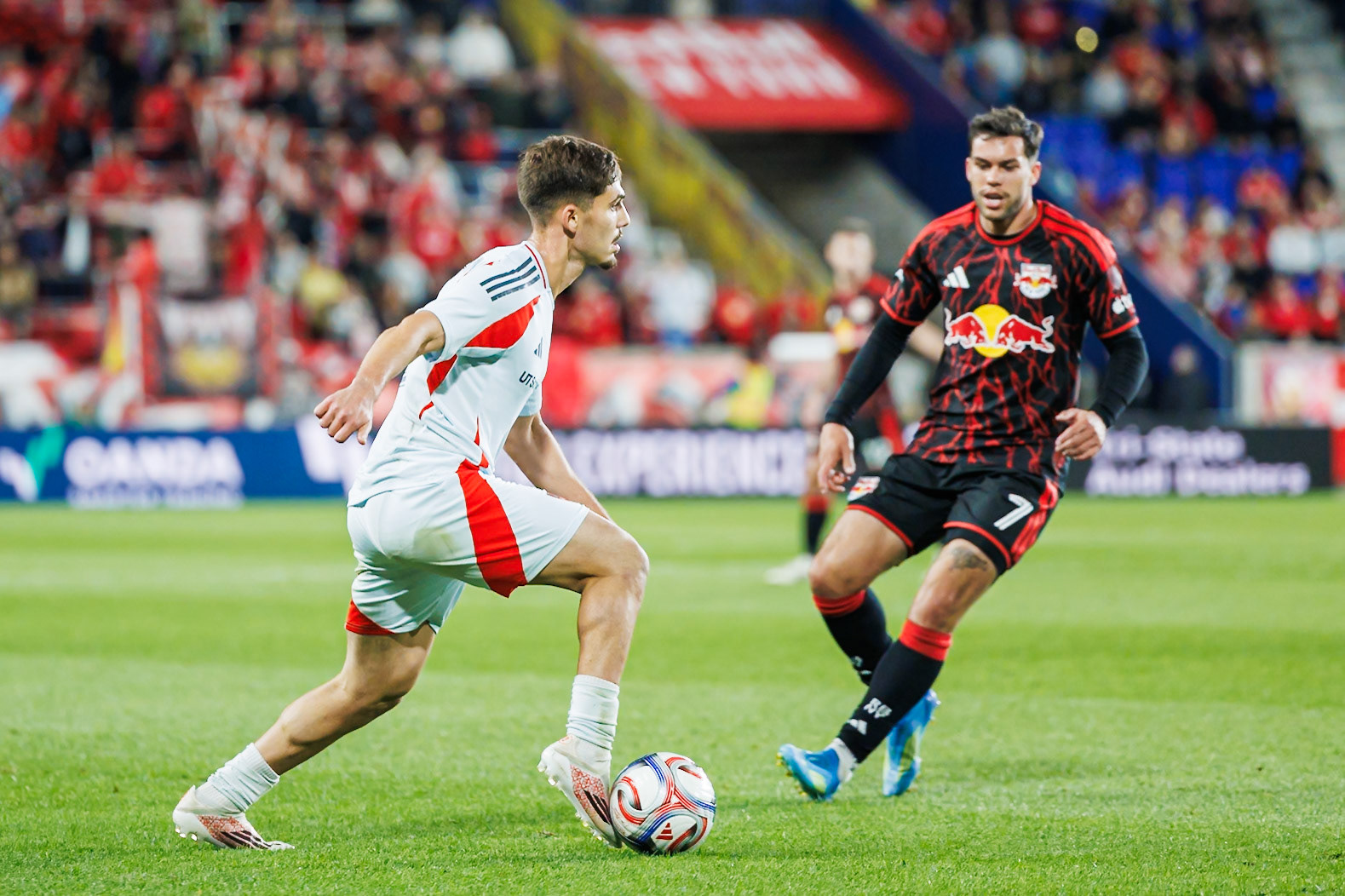 Ran Binyamin carries the ball forward against Cade Cowell.