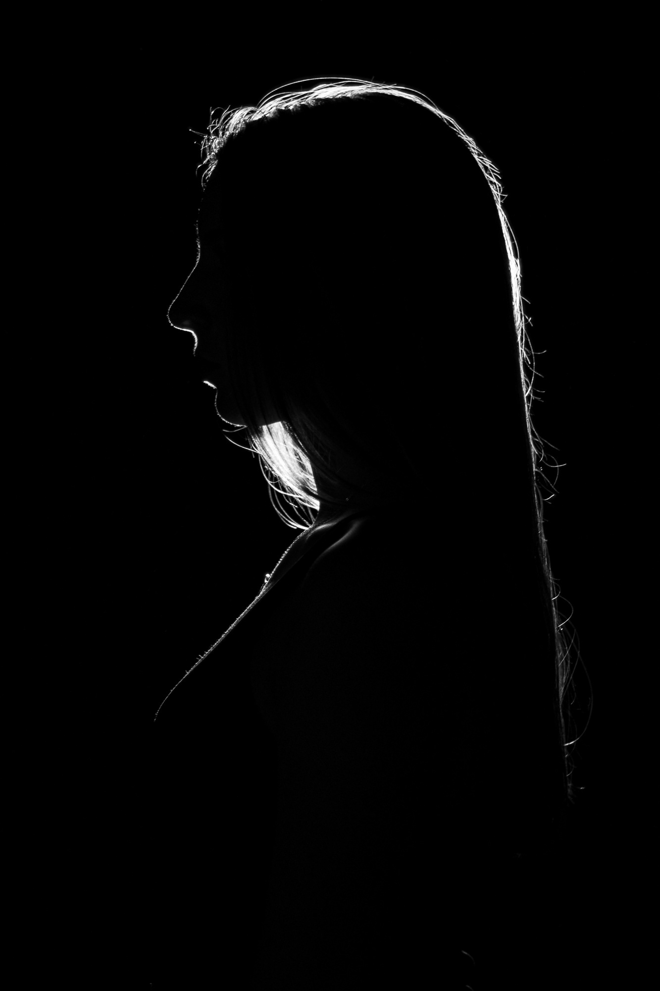 Silhouette of a woman's side profile in black and white