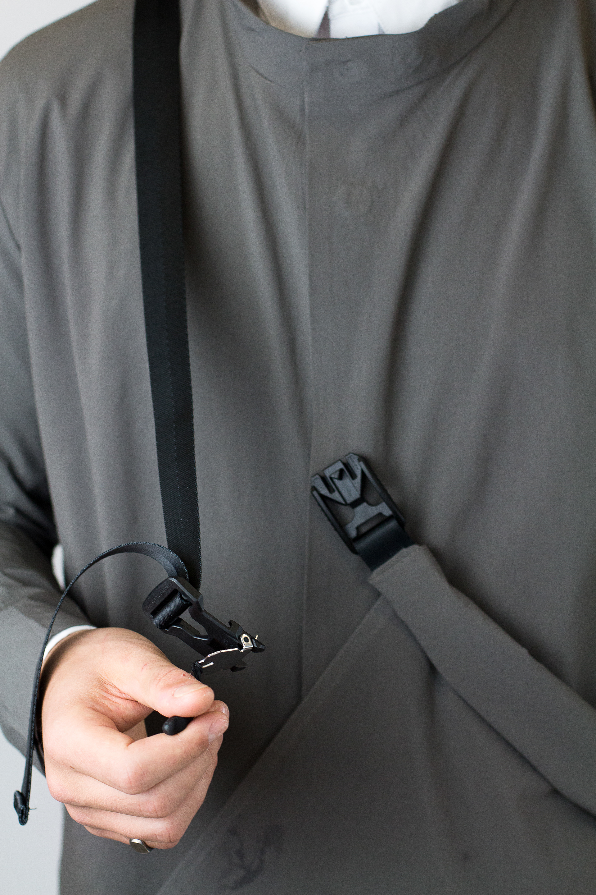 Buckle lines up with middle button jacket to hold bag in place when changing.
