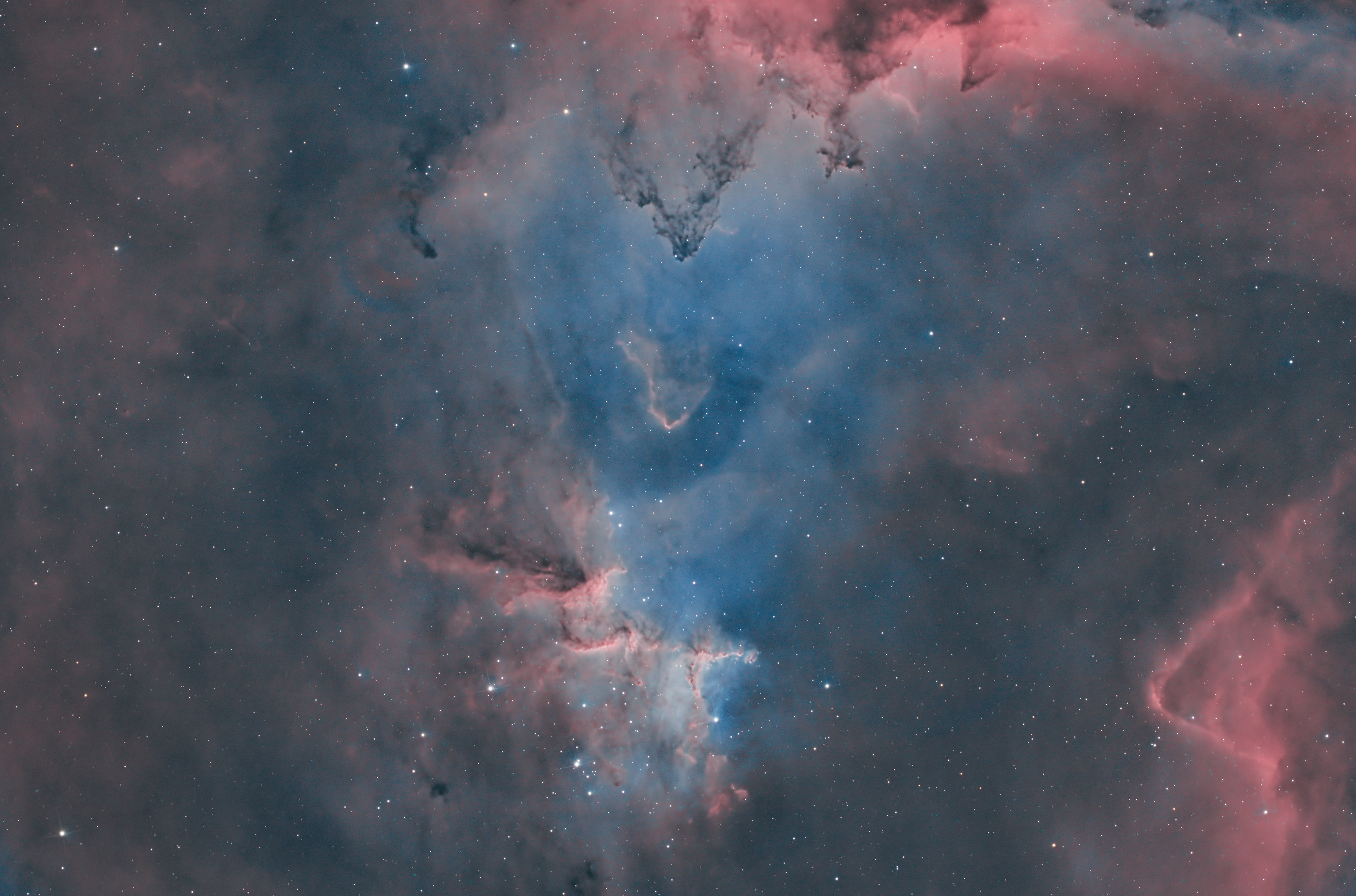 Melotte 15 is a dazzling open star cluster situated at the heart of the Heart Nebula (IC 1805) in the constellation Cassiopeia, approximately 7,500 light-years from Earth. The cluster is home to a collection of young, massive stars, some of which are several times more massive than our Sun. These stars produce powerful stellar winds and intense ultraviolet radiation, which sculpt the surrounding gas and dust into striking formations, including pillars, ridges, and intricate shapes reminiscent of those in the Pillars of Creation within the Eagle Nebula. The dynamic interactions within Melotte 15 contribute to the ongoing process of star formation, making it a fascinating region for astronomers studying stellar evolution and the influence of massive stars on their interstellar environments.