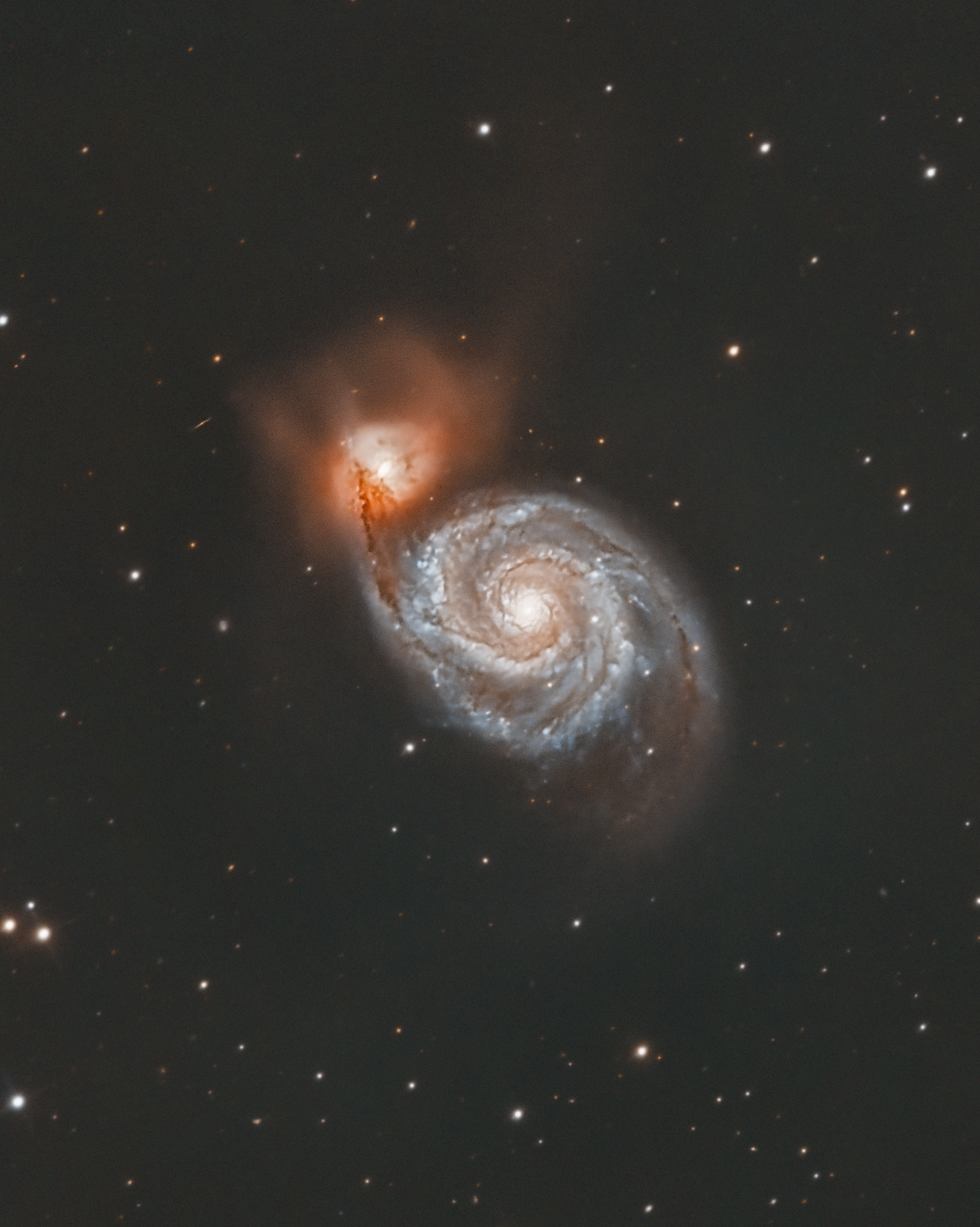 The Whirlpool Galaxy, also known as M51 or NGC 5194, is a stunning spiral galaxy located approximately 31 million light-years away in the constellation Canes Venatici. It is renowned for its grand-design spiral structure, showcasing well-defined spiral arms filled with young stars, pink star-forming regions, and dark dust lanes. The Whirlpool Galaxy is interacting with its smaller companion, NGC 5195, creating gravitational forces that enhance its spiral arms and trigger intense star formation. This galactic dance provides valuable insights into galactic interactions and evolution, making M51 a favorite target for both amateur and professional astronomers.