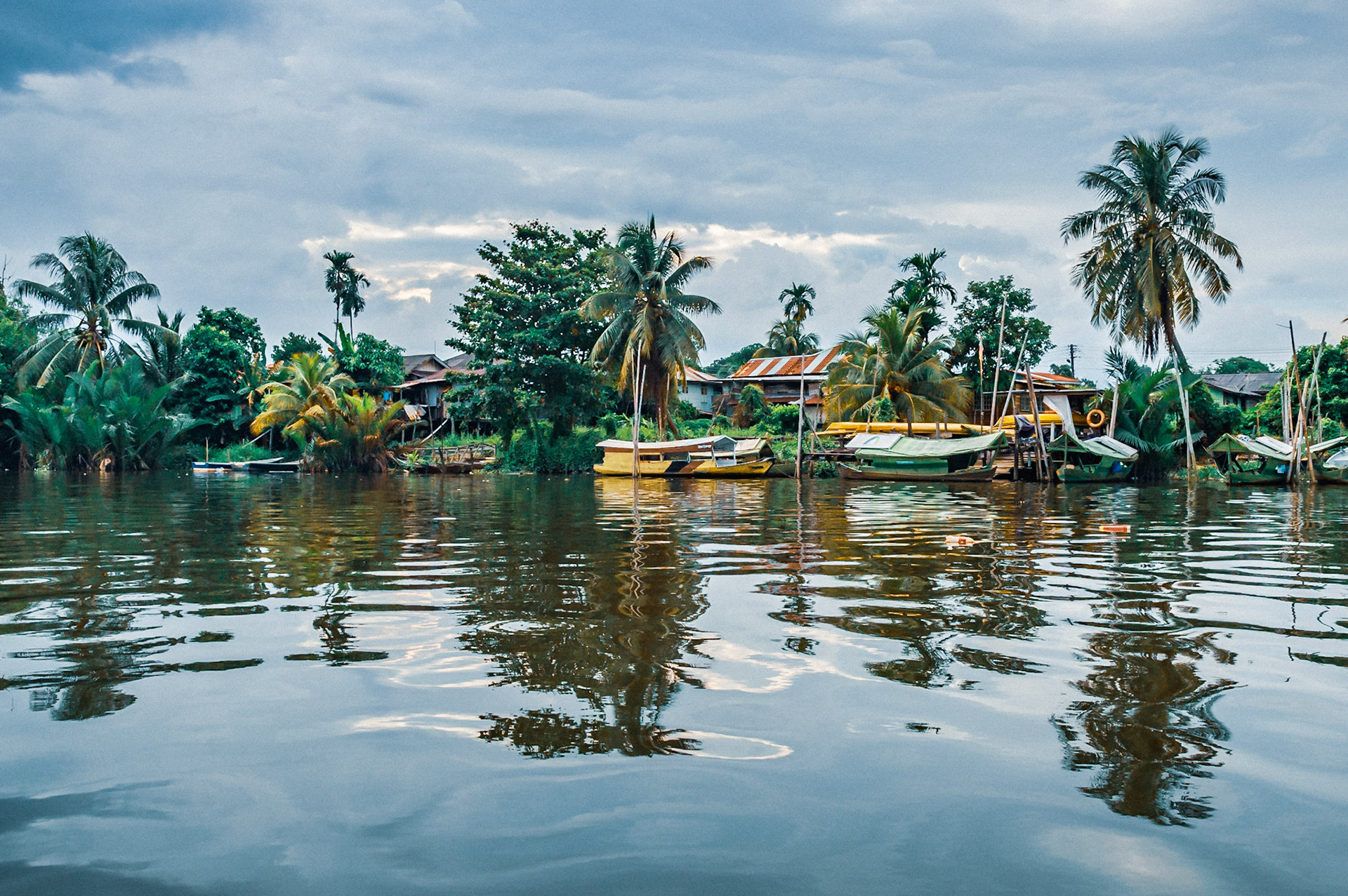 Taking an evening boat trip along the Sarawak River in Kuching. Dodging the showers as a summer storm passed by. From calm river reflections to dark tropical rain clouds and monsoon rain!