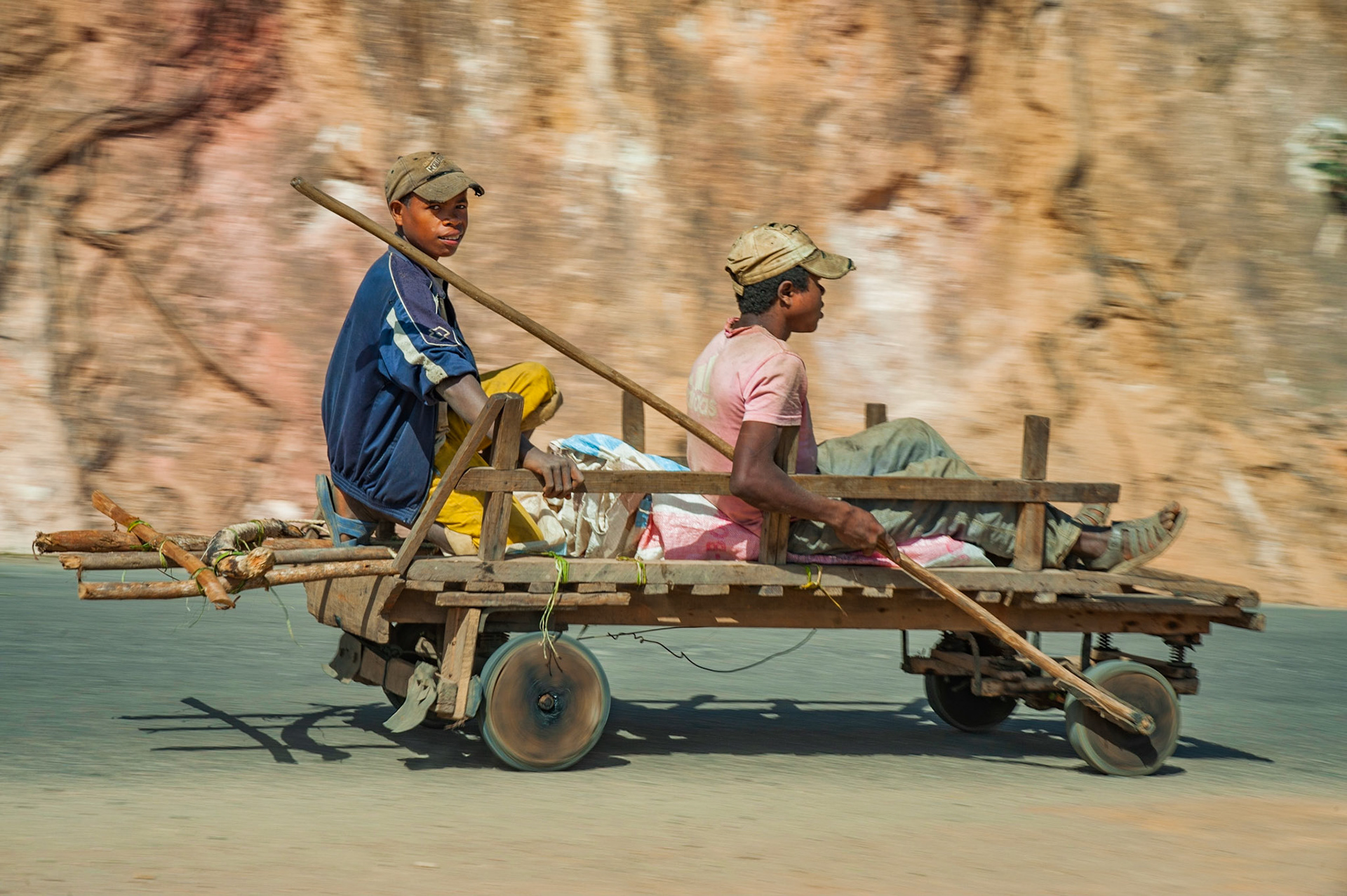 I heard this long before I knew what it was or could see it! These two came around the corner rather fast, and almost directly into on-coming traffic! I just got the manual settings in-time to real off this shot, and just as the passenger glanced a smile.