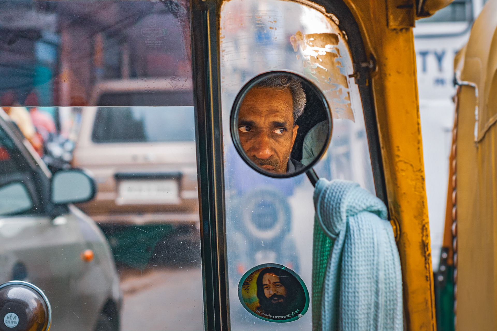 Stuck in traffic in between New and Old Delhi in an auto-rickshaw (tuk-tuk). I was intent on capturing a portrait of the driver, as he was so photogenic and was captivating me with his stories and expressions. Dodging cars, lorries, people and cows in the Indian streets does not make easy portrait conditions. But I managed this first candid shot, and then the second portrait where he just opened into this amazing smile!