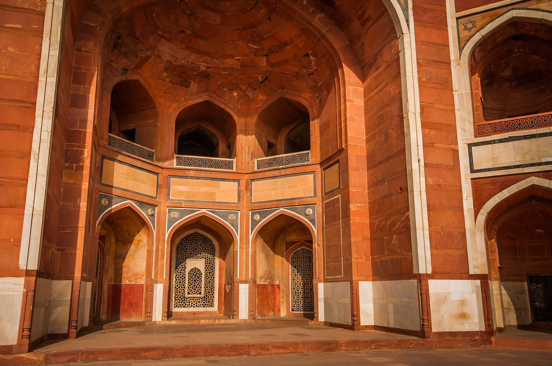 The resting place of the Mughal Emperor 'Humayun'. Found just outside of Delhi, India this is the  amazing orange sandstone facade of 'Humayun's tomb'.