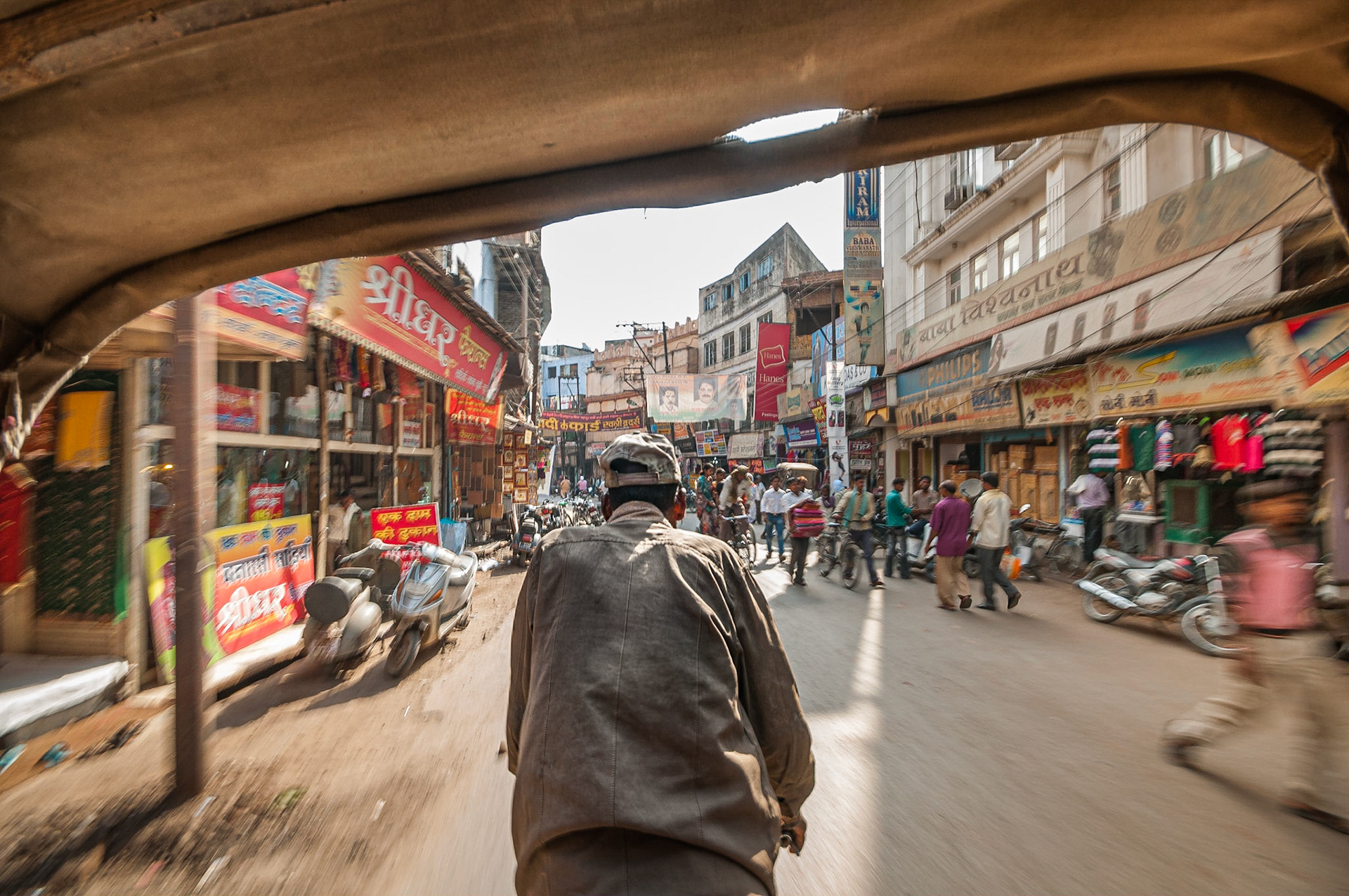 In the back of a cylce-rickshaw navigating the side streets of Varanasi after getting lost in the market (again).