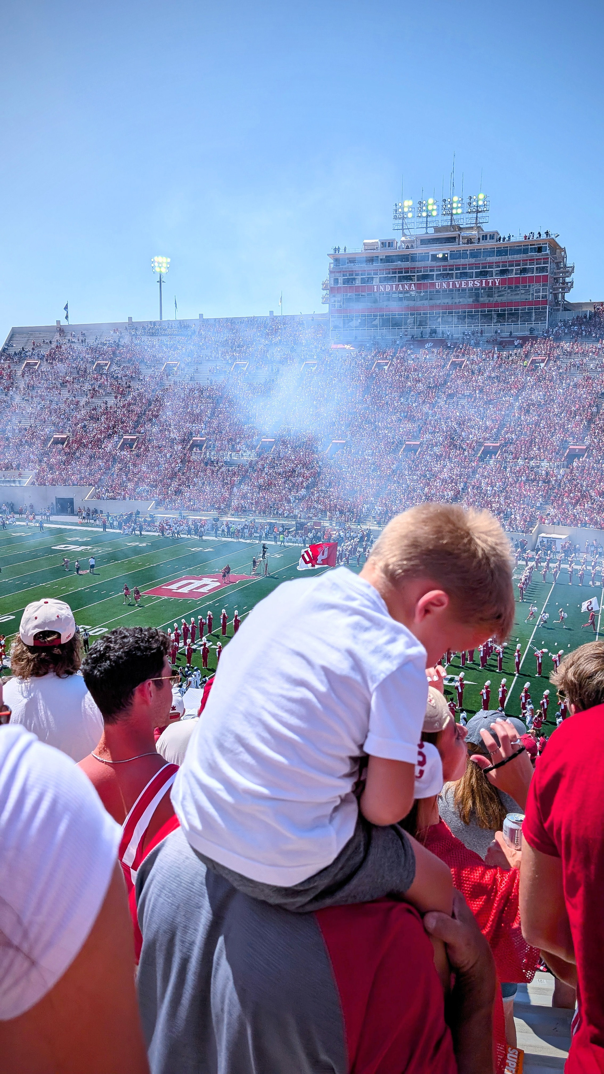 Boy on shoulders in stadium