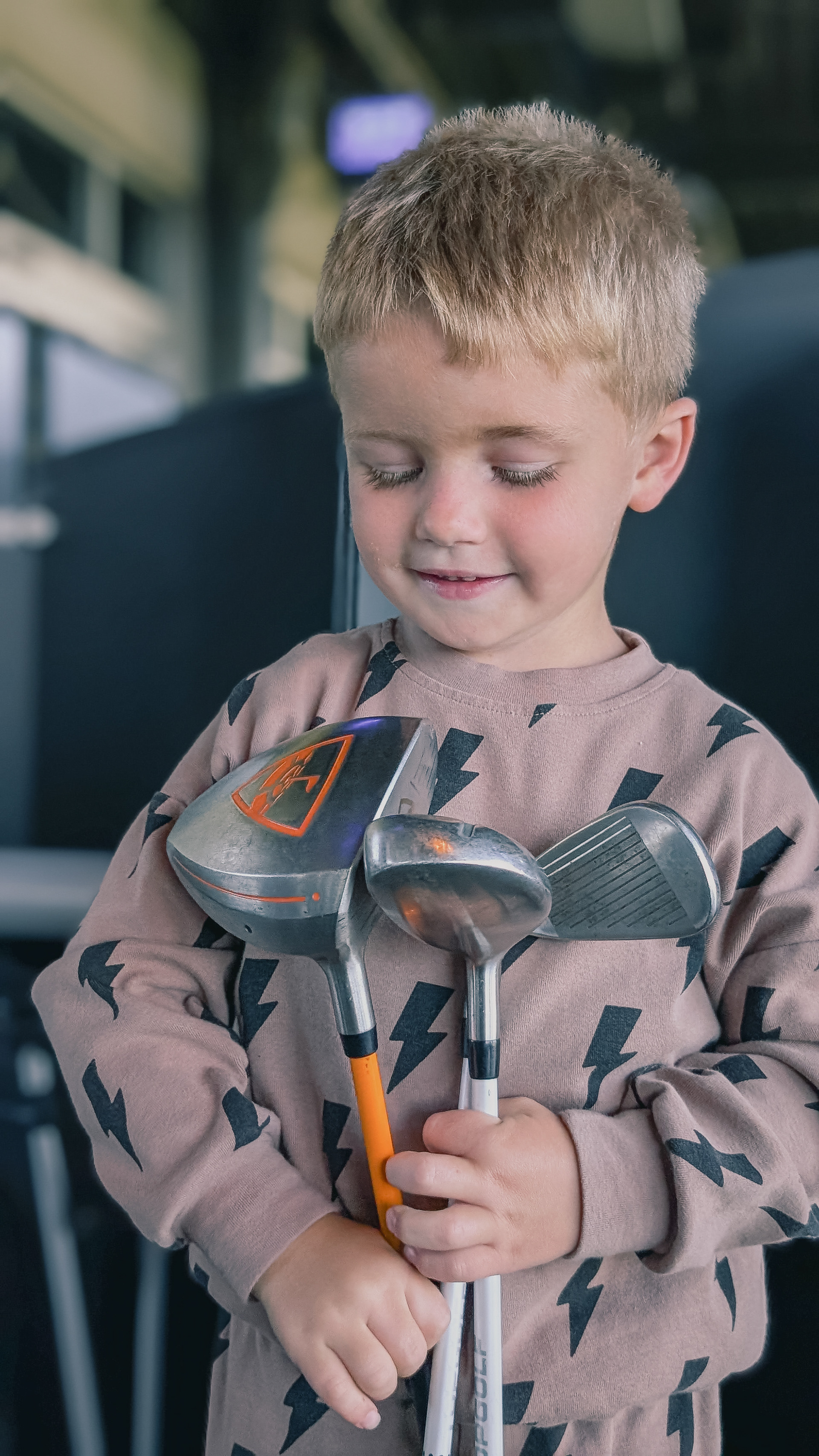 Boy and golf clubs