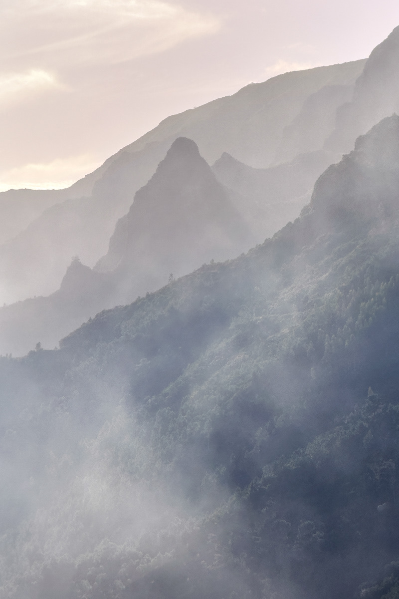 layers of mountains in a veil of clouds