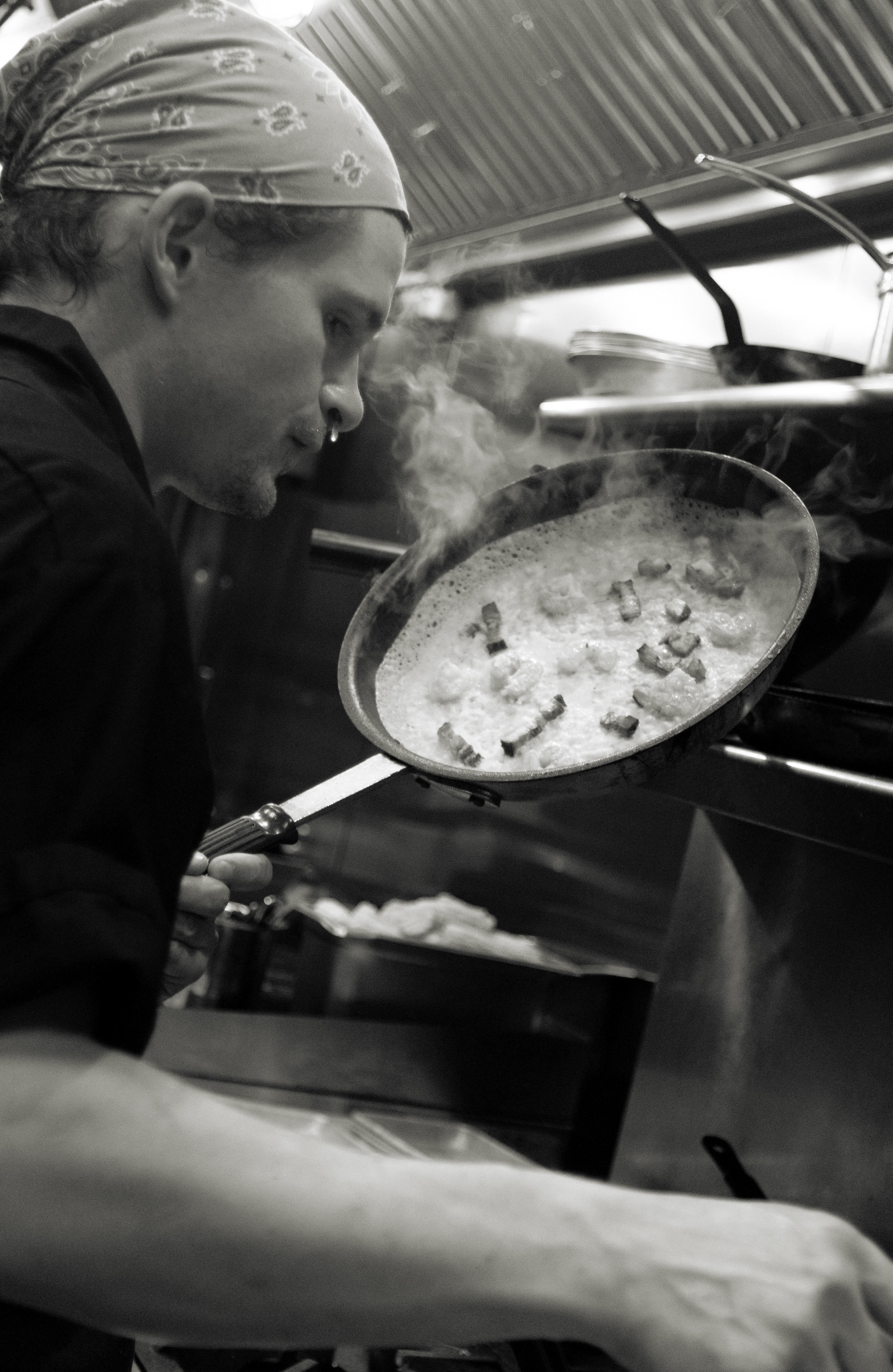 Chef Ryan Mikulka uses a hot pan to cook a dish at the Vietnamese restaurant Pretty Boy in downtown Athens, Georgia on Nov. 14, 2024.