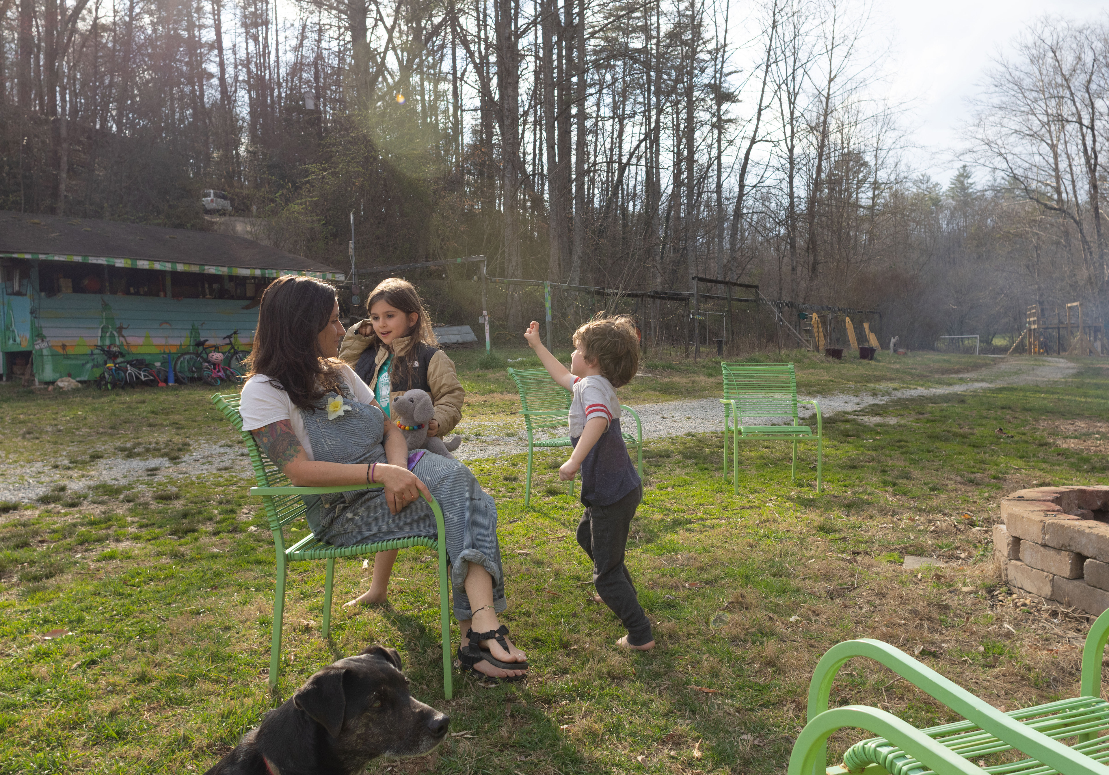 Nicole Kelley interacts with her children Winnie O'Day (8) and Hank O'Day (5) as they play in their backyard in Rabun County, Ga on March 14, 2025. One of the family's dogs, Little Bear, accompanies them. (Photo / Lux Corrona)