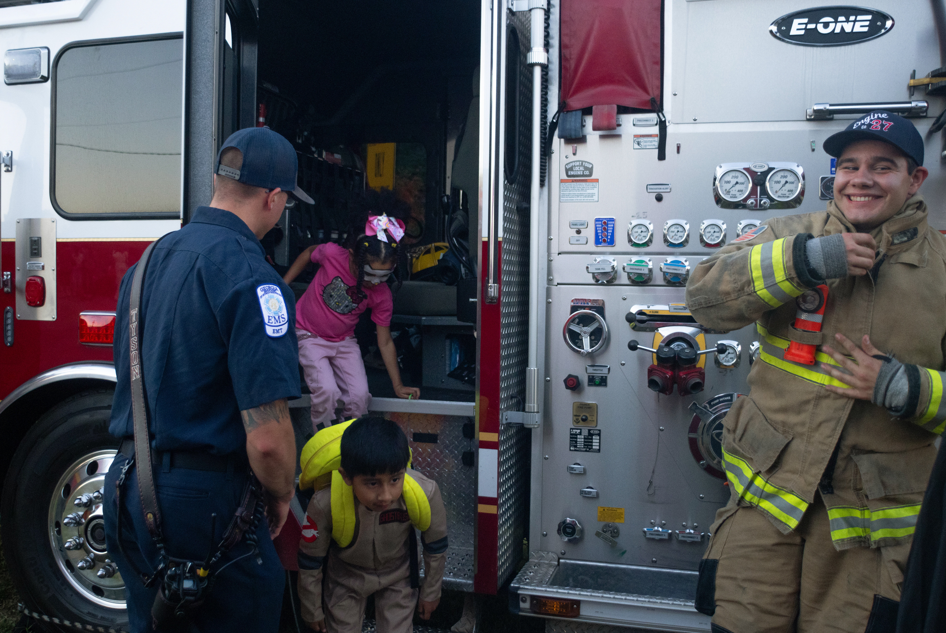 Camila Jefferson and Ian Rojas exit a firetruck after exploring the inside of it at the third annual fall festival hosted by the Clark County Sheriff's Office on Oct. 25, 2024. Clark County firefighter Edward Bridges smiles and greets event attendees.