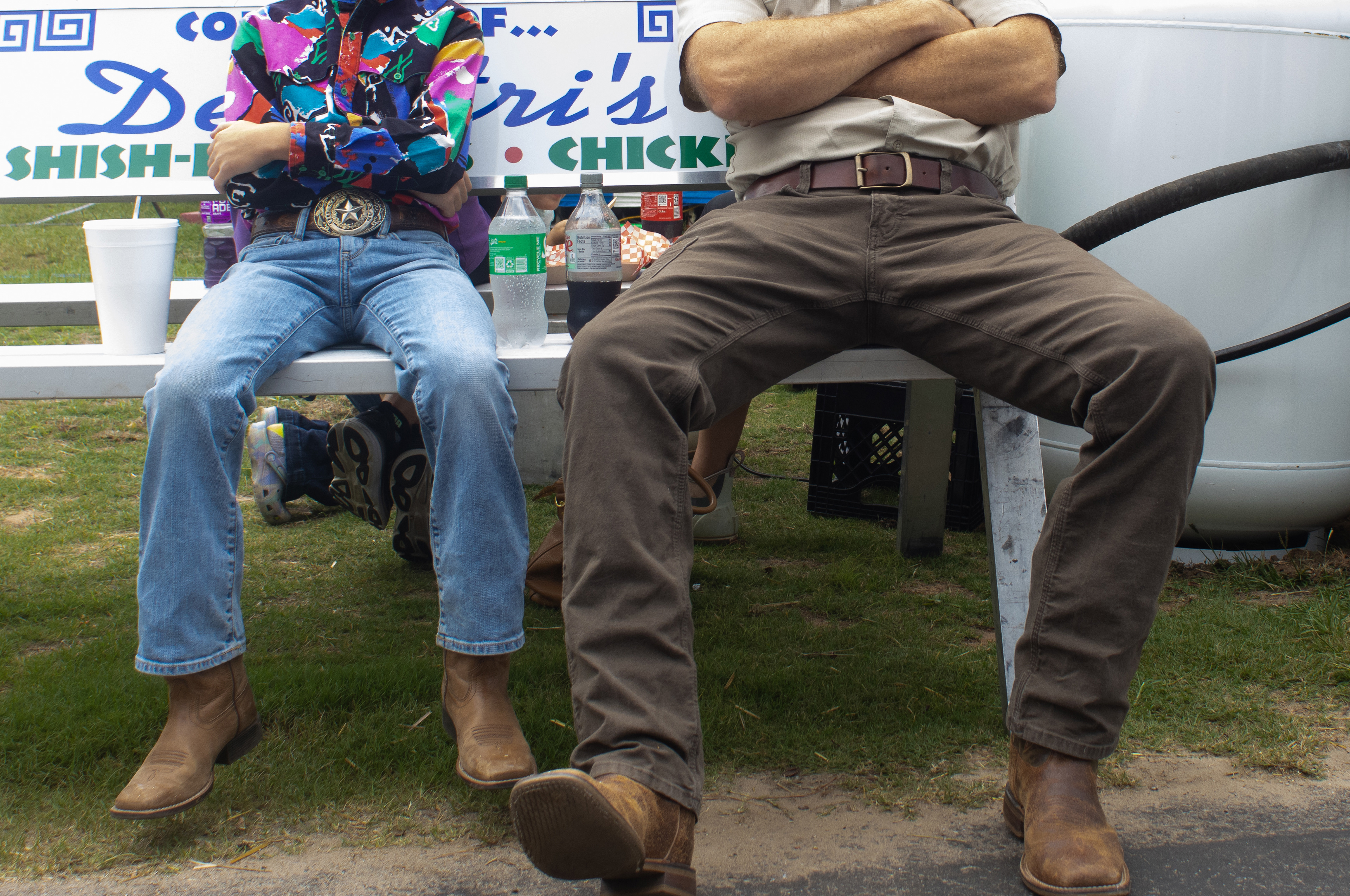 Wyatt Tyson of Statesboro, Georgia, 10, sits beside his father Nathan Tyson at the Georgia National Fairgrounds and Agriculture Center on Oct. 5, 2024. Wyatt is dressed to show lambs this year at the fair. 
