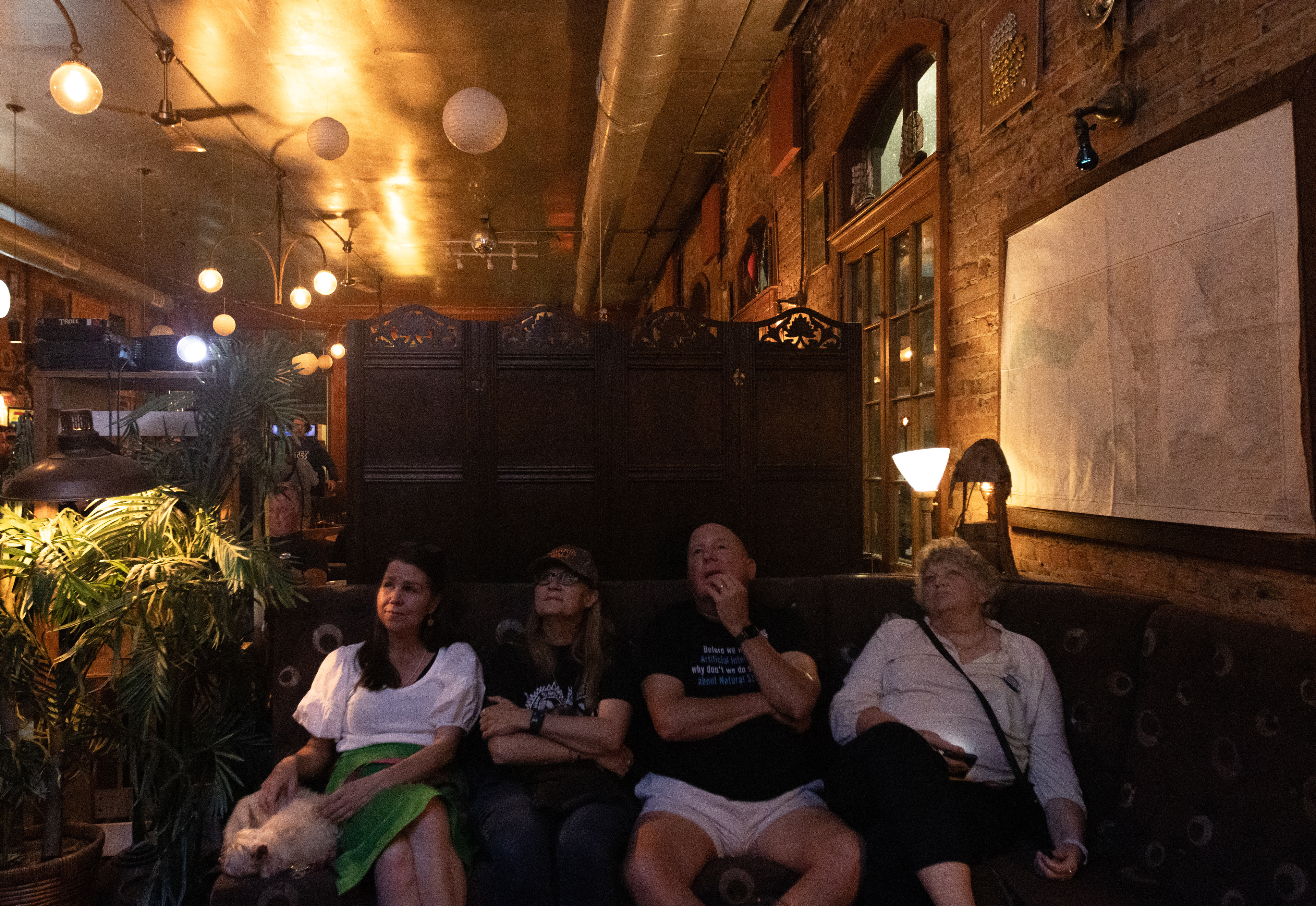 From left: Jessica Fore, Frances Hughes, Charles Gisler, and Sherry Gisler intently watch the presidential election at Little King's democratic "watch party" in downtown Athens, Georgia on Nov. 5, 2024. 