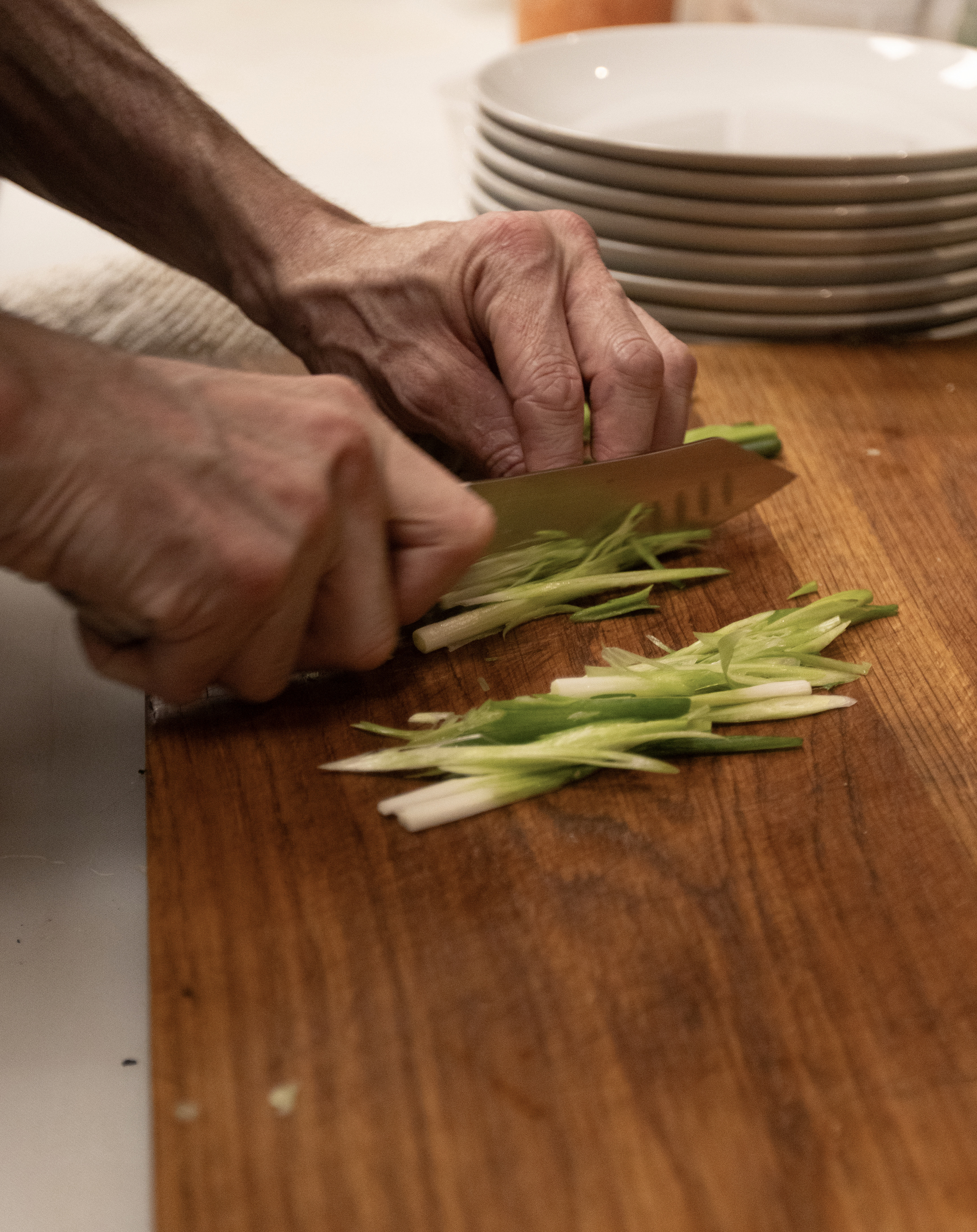 Chef Bradley Austin cuts up chives to prepare a dish at Pretty Boy, the new Vietnamese restaurant in downtown Athens, Georgia on Nov. 14, 2024.