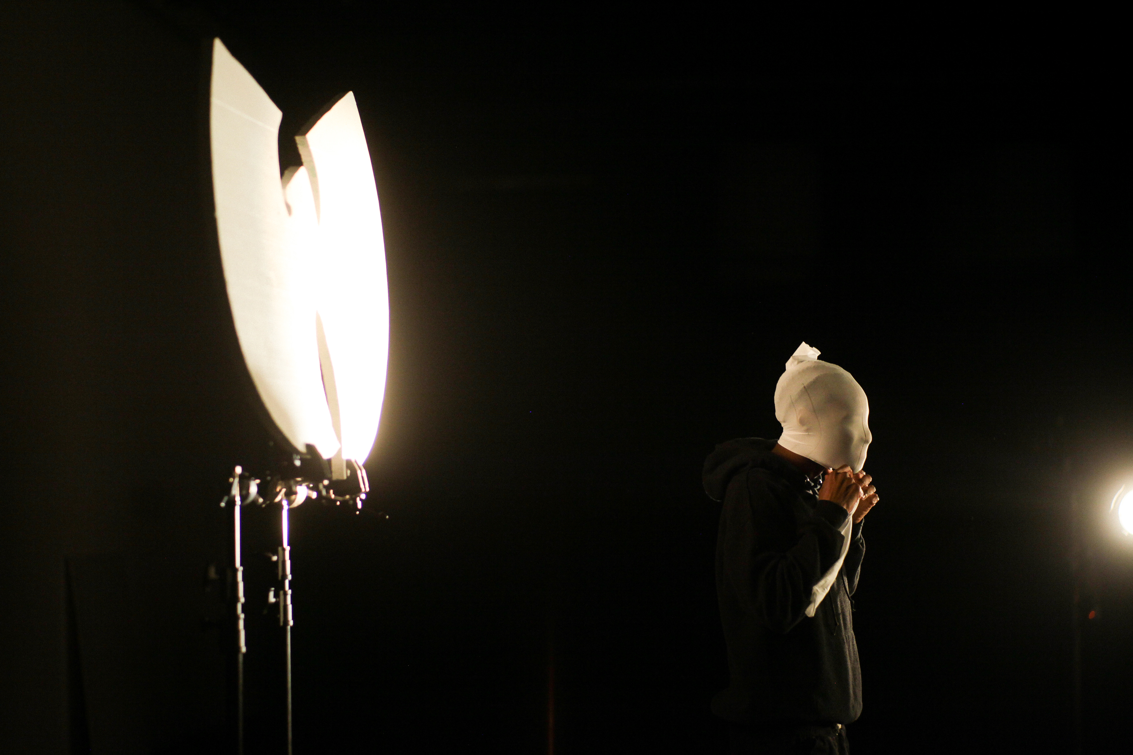 An extra acting in rap artists Lecrae and Andy Mineo's "Been About It" music video adjusts his mask in Atlanta, Ga, on July 28, 2021.