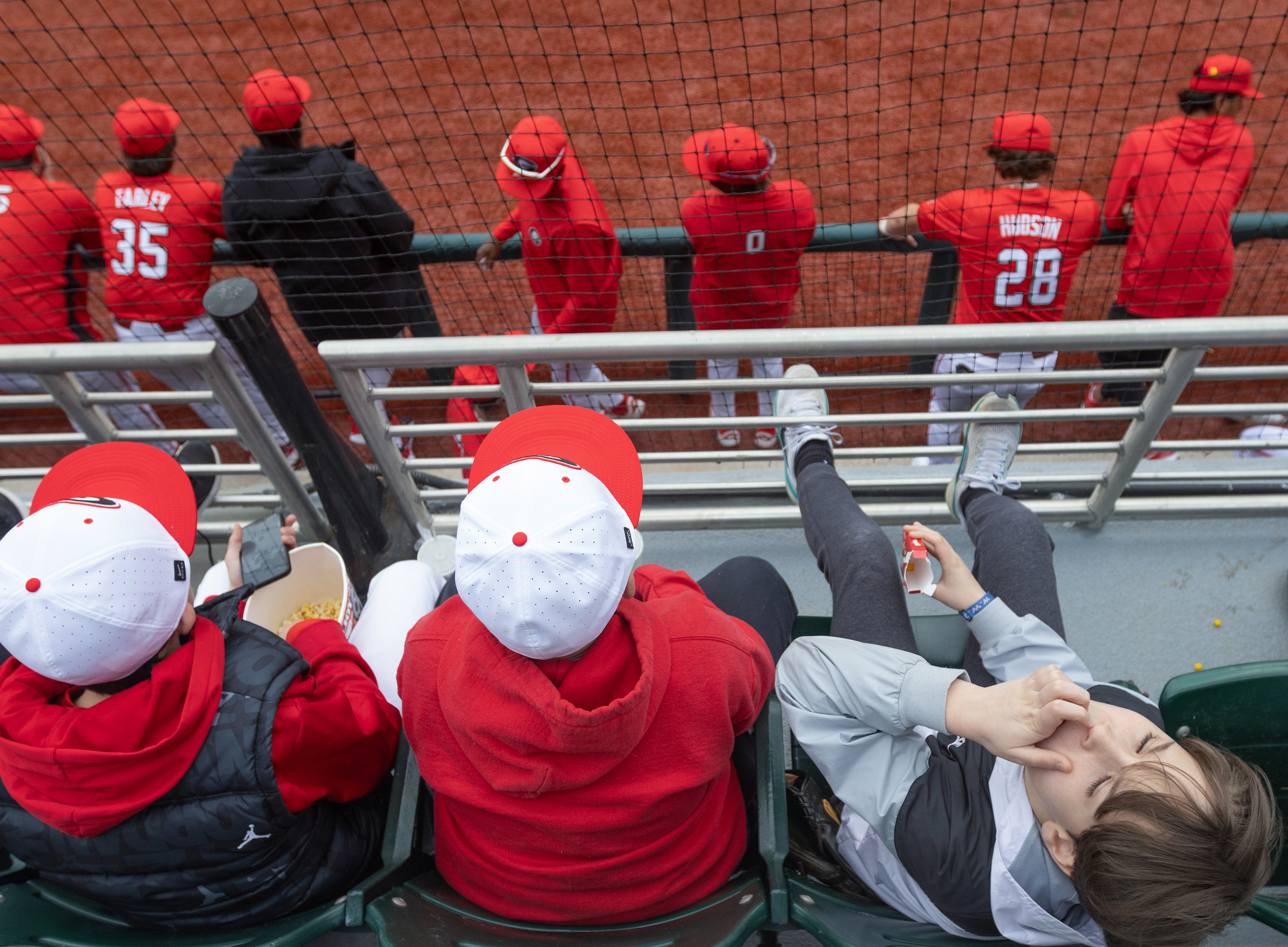 Coleman Jones eats Skittles while he watches a game between opposing team UIC and Georgia at Foley Field in Athens, Georgia, on Saturday, Feb. 22, 2022. Georgia won 10-4. 