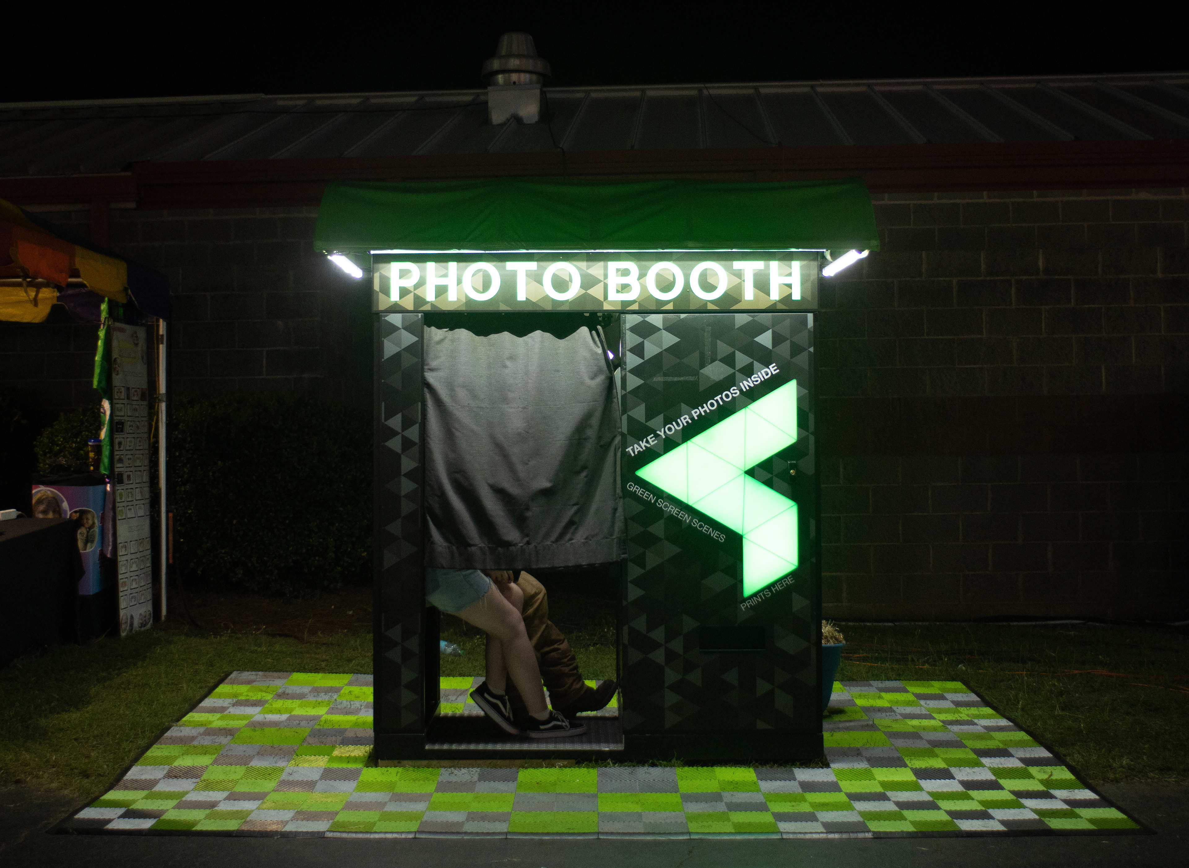 Fairgoers sit inside of a photo booth at the Georgia National Fairgrounds and Agriculture Center on Oct. 5, 2024.
