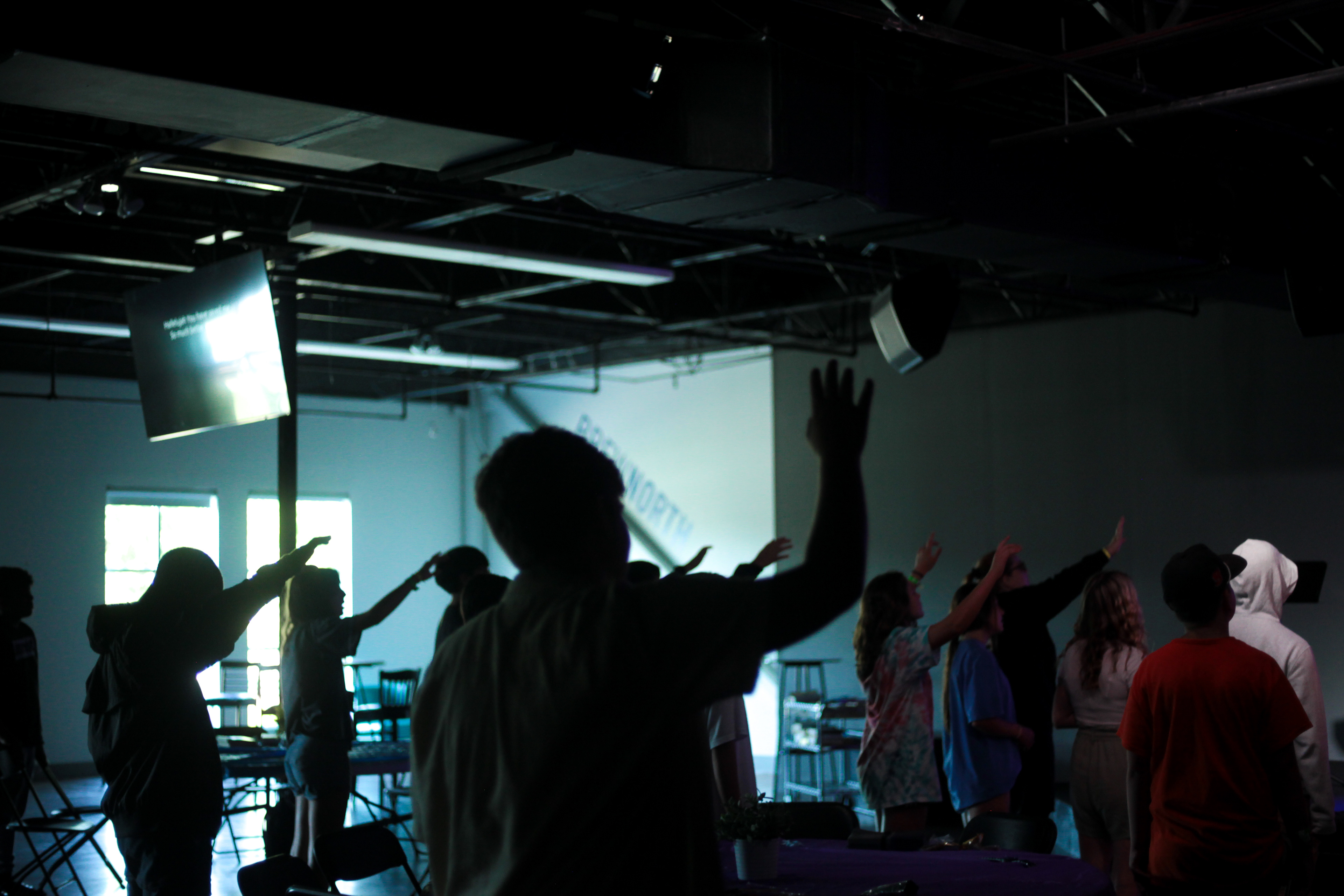 Middle school students at Grace Snellville church in Snellville, Ga lift their hands to worship music. July, 2021.
