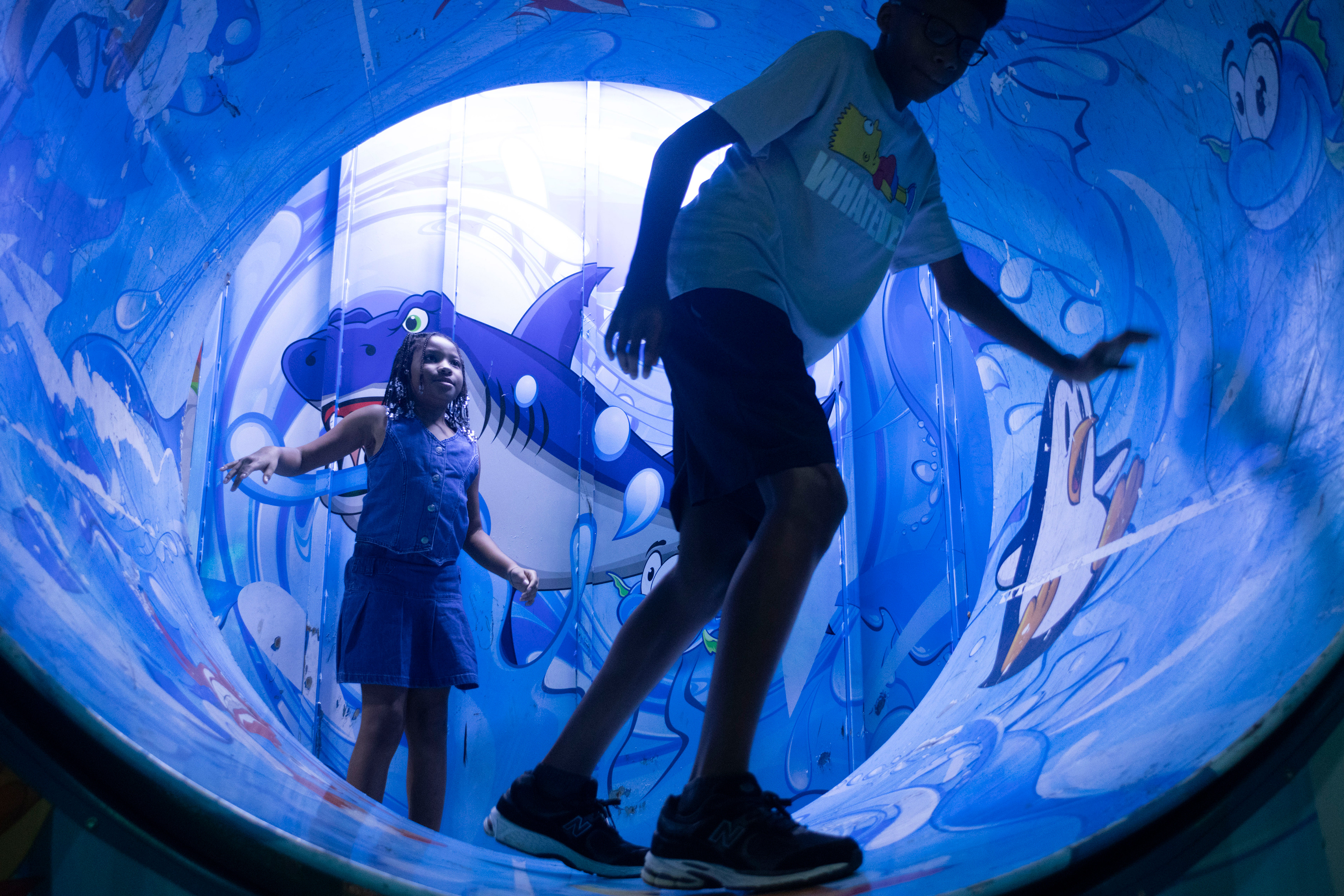 Mariah Little, 13, and Mahki Little, 8, exit a funhouse at the Georgia National Fairgrounds and Agriculture Center on Oct. 5, 2024.