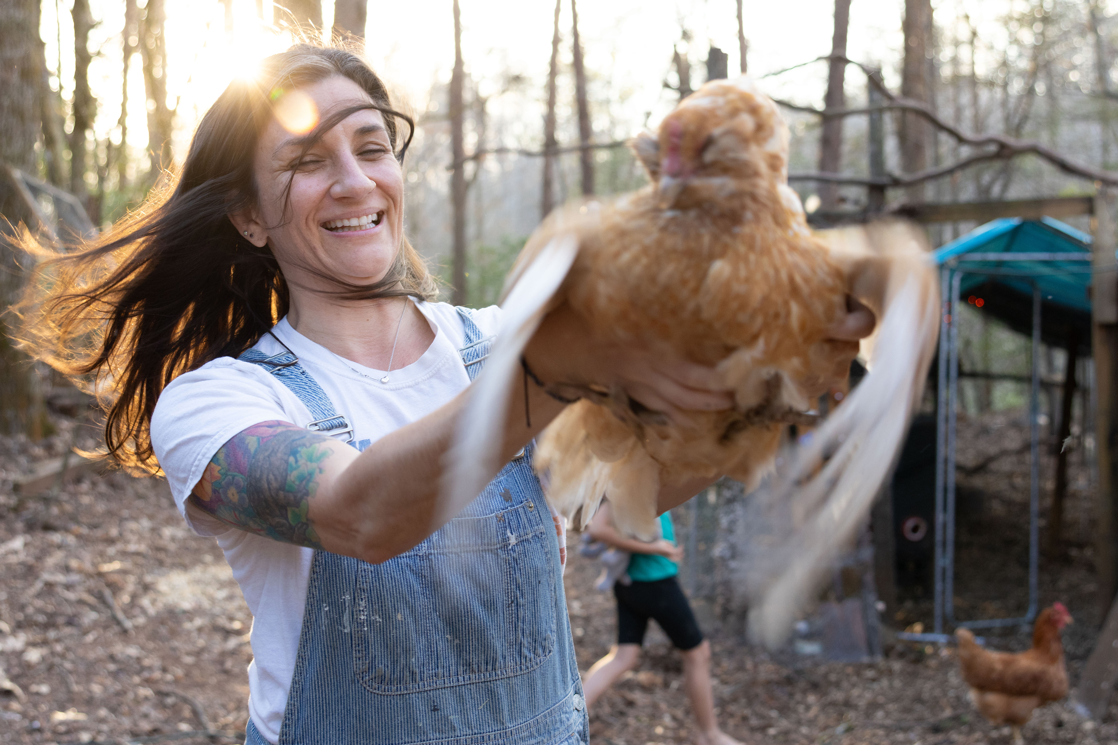 Nicole Kelley holds a chicken named Henny Penny at her home in Rabun County, Ga on March 14, 2025. Kelley and her family usually let their chickens roam free in the afternoon, trusting they will return back to the coop when it gets dark. 
